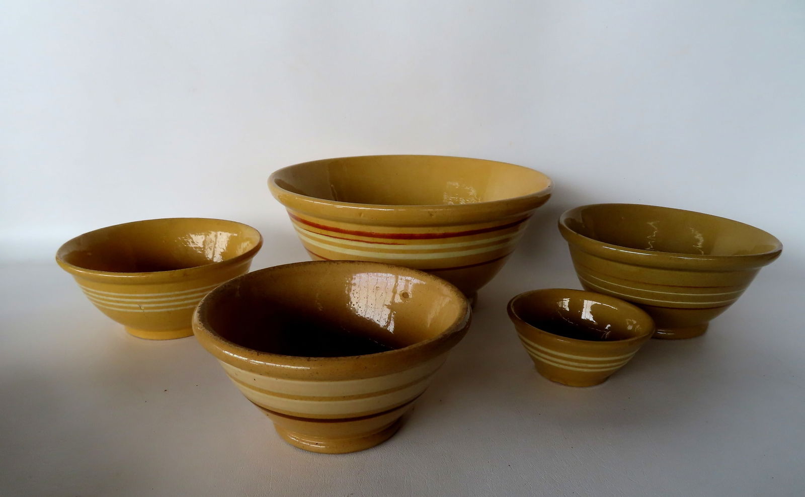 Five yellowware mixing bowls - white and brown bands on most. The largest measures 12 7/8" diameter (1 of 10)