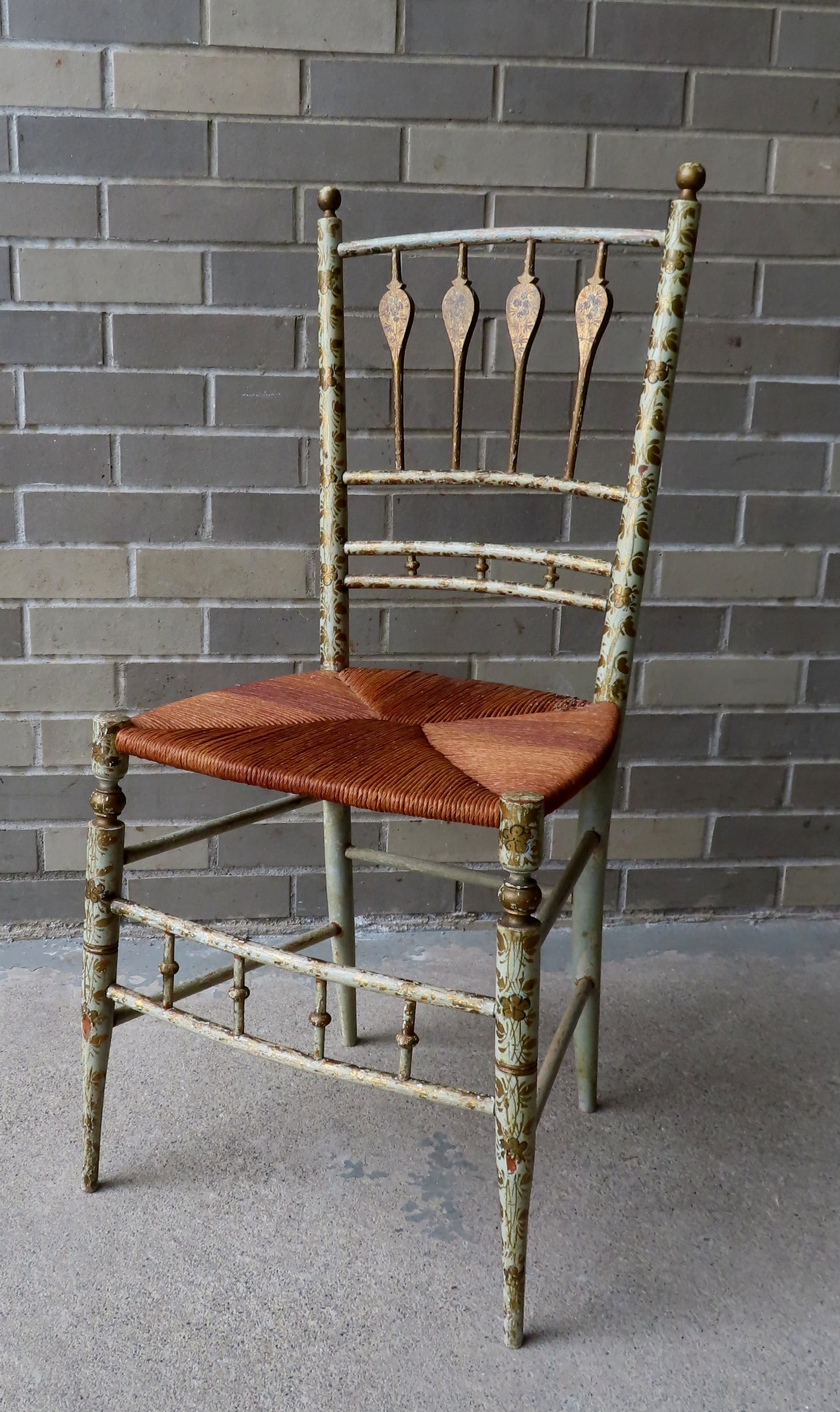 A Sheraton side chair in original paint, decorated with flowers and leaves, early 19th century. The: A Sheraton side chair in original paint, decorated with flowers and leaves, early 19th century. The original seat has been replaced with faux rush - overall good condition. Measures 15 1/2"W x 15"D x 