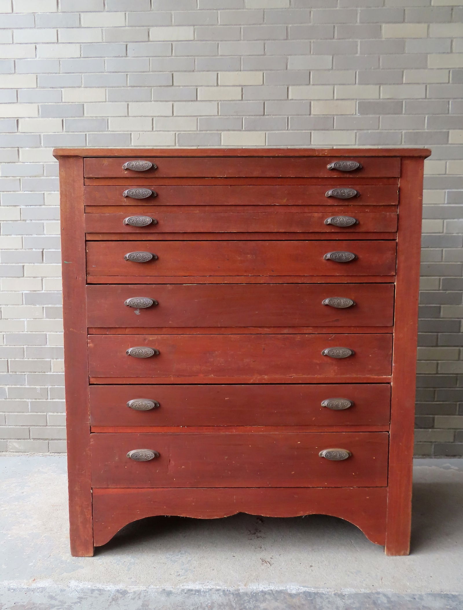 A country artist chest with 8 narrow drawers, ranging in size from 2 3/4"H to 6 3/4"H. Original iron: A country artist chest with 8 narrow drawers, ranging in size from 2 3/4"H to 6 3/4"H. Original iron pulls, cutout base, circa 1875. Some use wear, but overall good condition. Measures 43"W x 24"D x 4