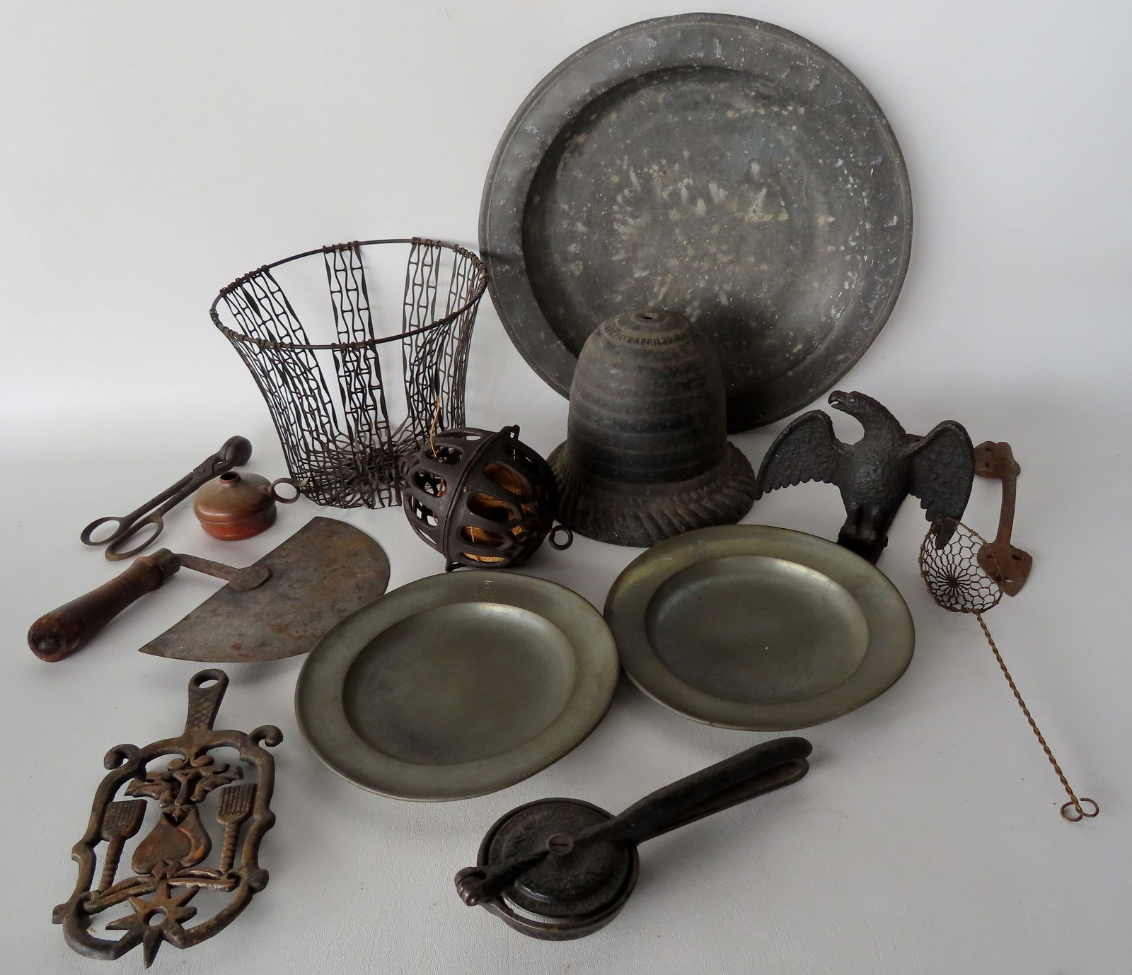 Grouping of country collectibles, most 19th century, including: A cast iron trivet decorated with (1 of 11)