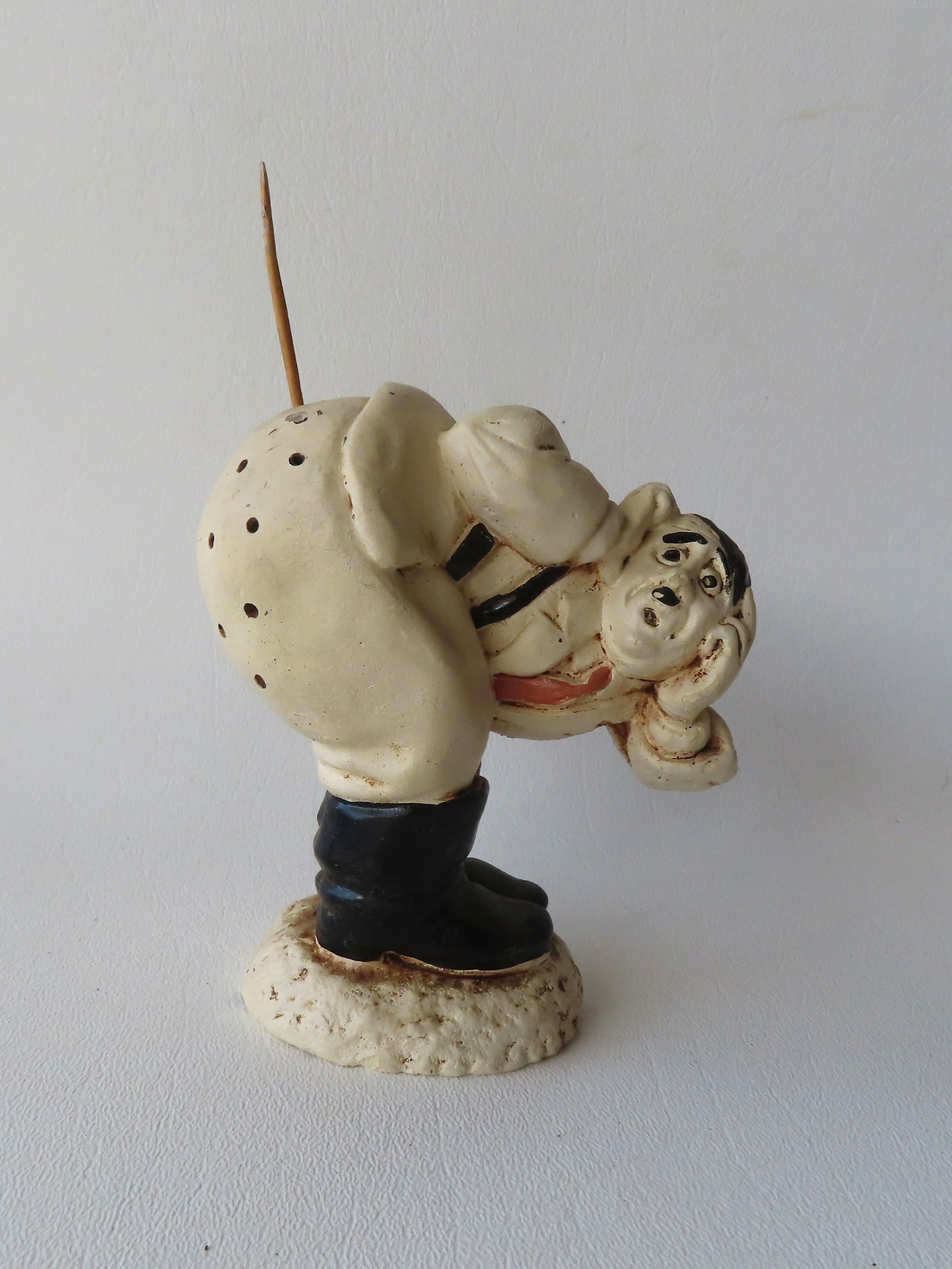 A WWII anti-Hitler figural plaster toothpick holder in the form of Hitler bending over exposing his: A WWII anti-Hitler figural plaster toothpick holder in the form of Hitler bending over exposing his buttocks which is riddled with holes for toothpicks. Similar example in the US Holocaust Memorial Mu