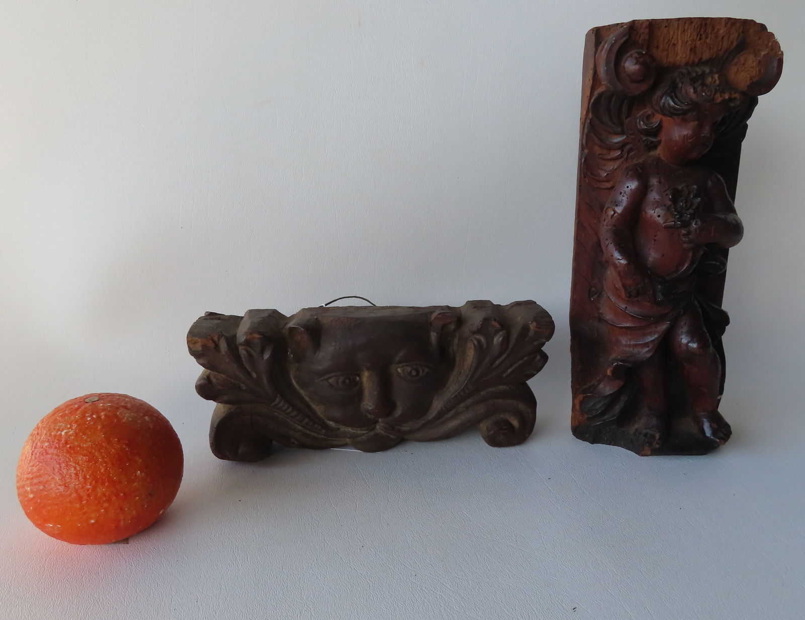 Two early hand carved wooden sculptures. The first, the largest, depicting a cherub figure holding (1 of 7)