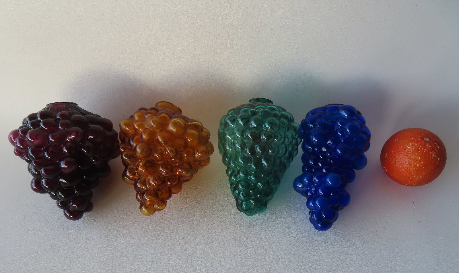 Grouping of 4 colorful glass grape shaped hanging globes. Includes matched pair in cranberry and: Grouping of 4 colorful glass grape shaped hanging globes. Includes matched pair in cranberry and amber - 5 3/4"H x 4 1/4"W - the cranberry retains original chain hanger and is in very good condition -