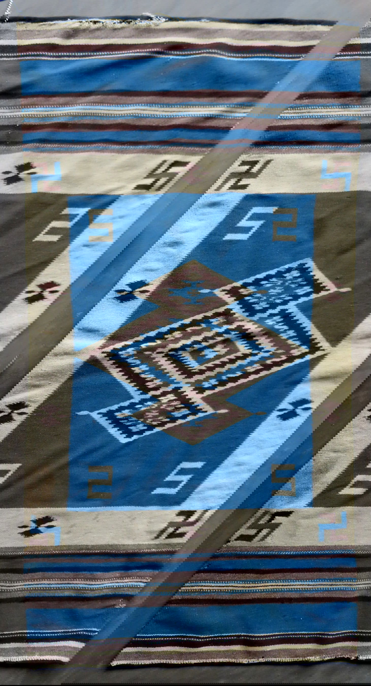 A Native American flat woven rug, probably Chimayo, late 19th to early 20th century. Loose yarn on (1 of 8)