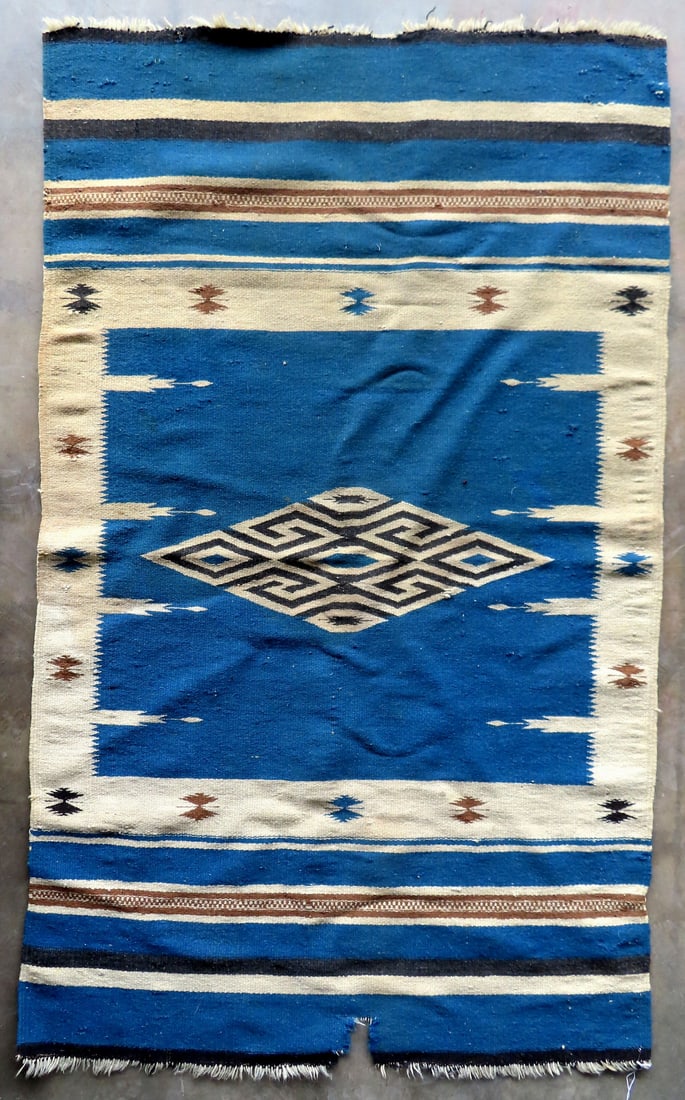 A Native American flat woven rug, probably Chimayo, late 19th to early 20th century. Small stained (1 of 8)