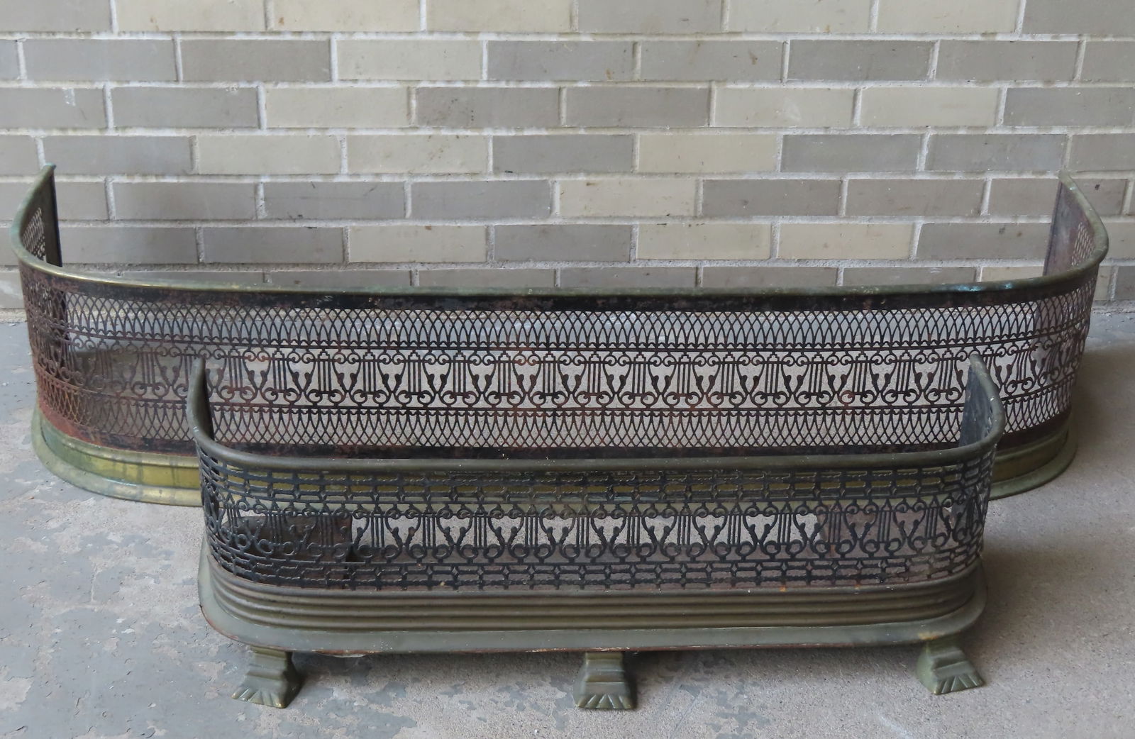 Two early fireplace fenders with iron and brass frames, with open work screens decorated with (1 of 12)
