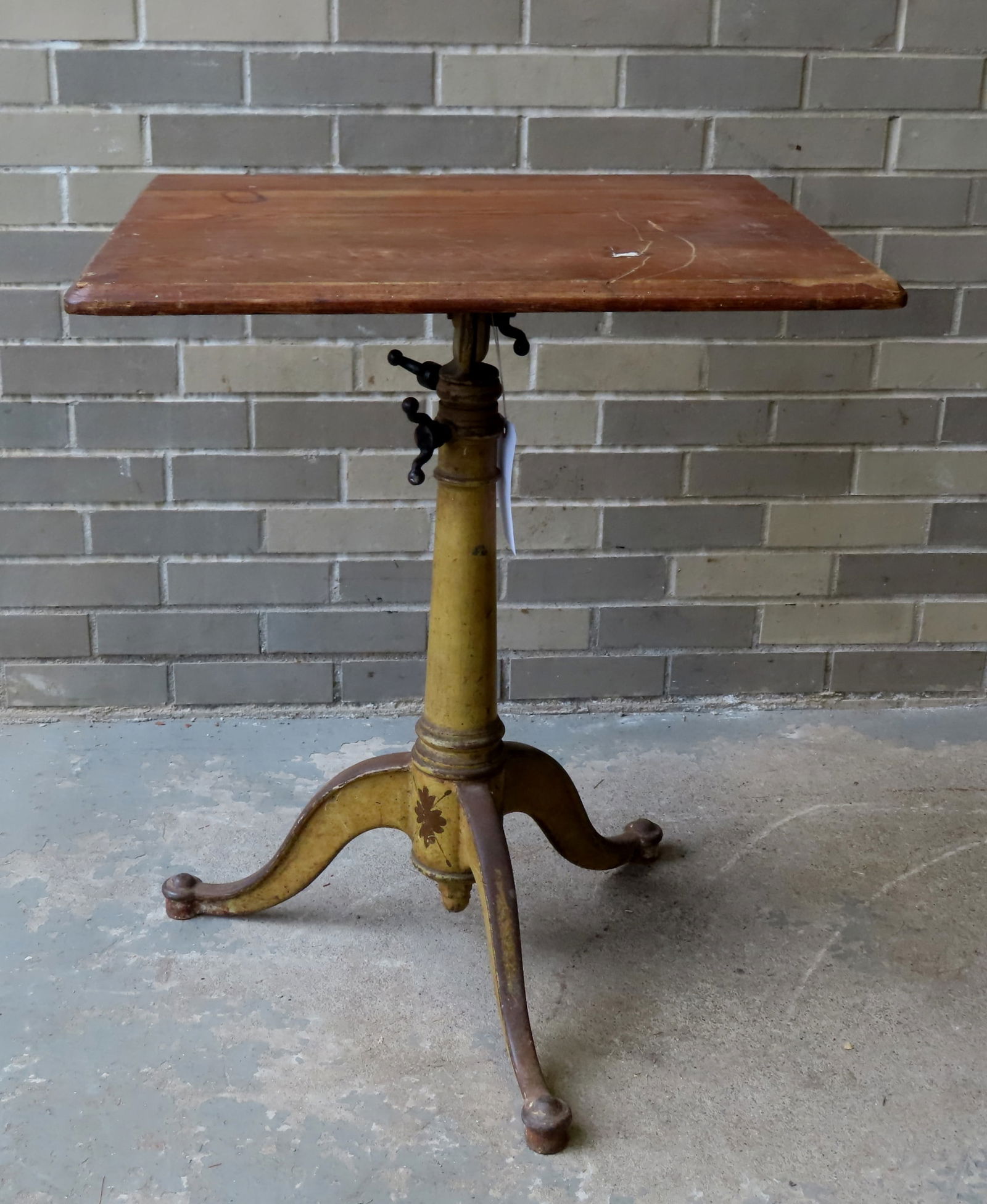 An adjustable architects cast iron table with wood top. The cast iron base in original mustard paint (1 of 9)