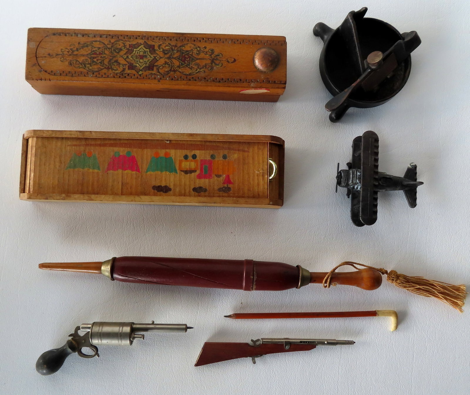 Grouping of lead pen and pencil related collectibles including: 2 wooden pencil boxes with slide: Grouping of lead pen and pencil related collectibles including: 2 wooden pencil boxes with slide lids; a carved wooden umbrella shaped pencil or paint brush holder, late 19th century, measuring 12 3/8