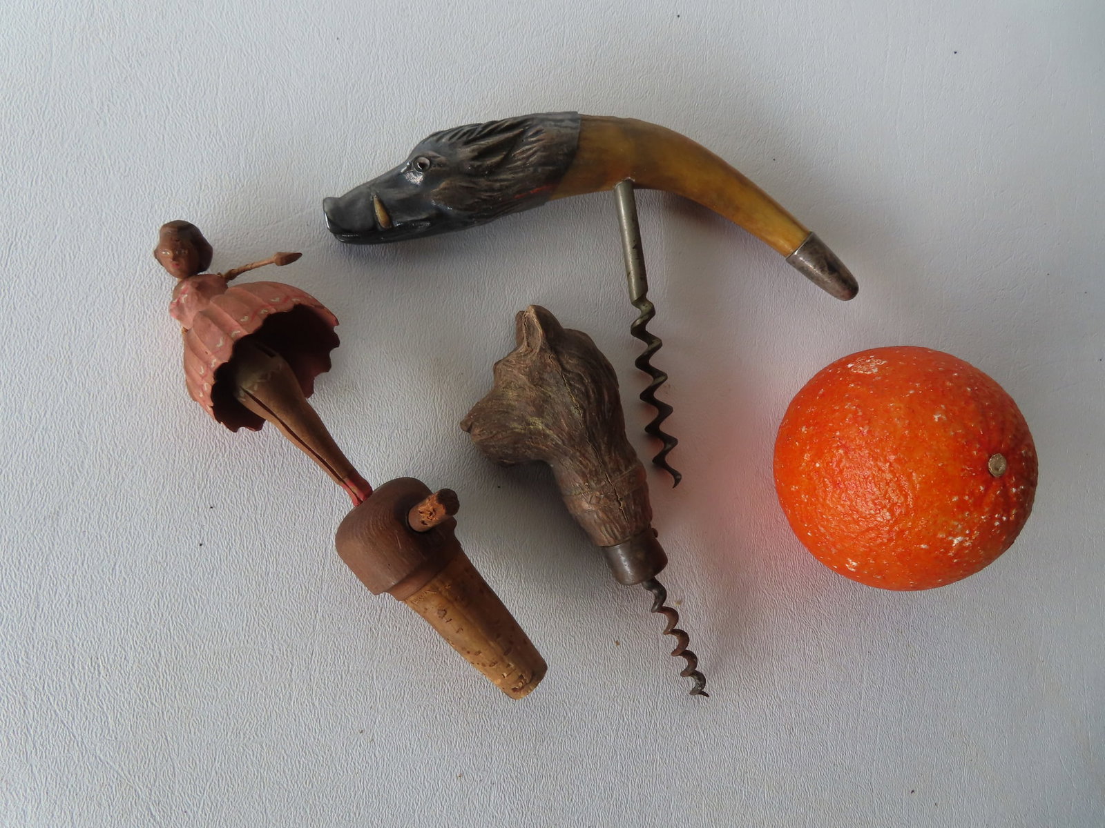 Two vintage cork screws and figural bottle stopper. Includes a wild boar tusk cork screw with: Two vintage cork screws and figural bottle stopper. Includes a wild boar tusk cork screw with applied silver handle in the form of a wild boar with glass eyes, late 19th to early 20th century - measur