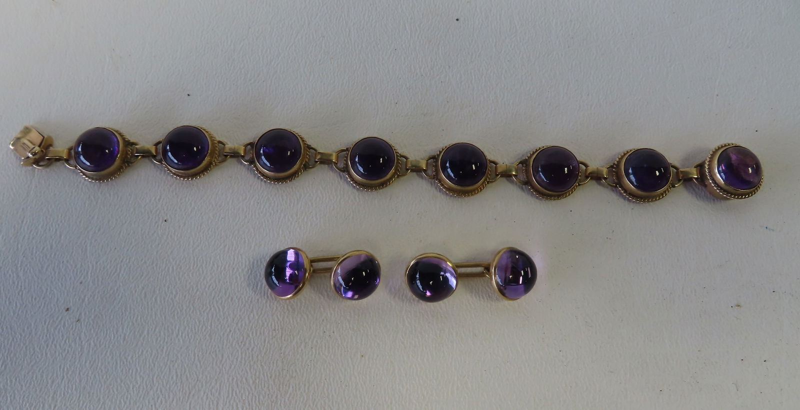 A marked 14k gold bracelet and matching cufflinks with amethyst colored stones (1 of 5)