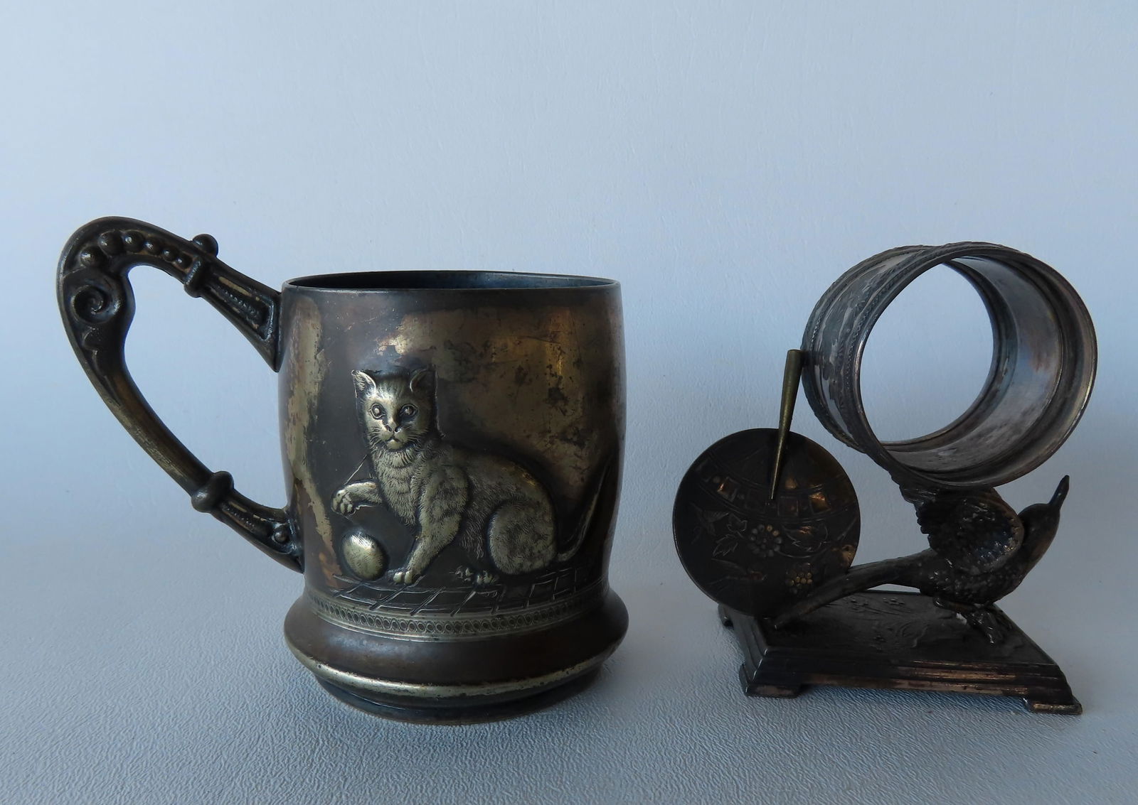 Two Victorian silver plated collectibles. The first, a figural napkin ring decorated with a spread (1 of 9)