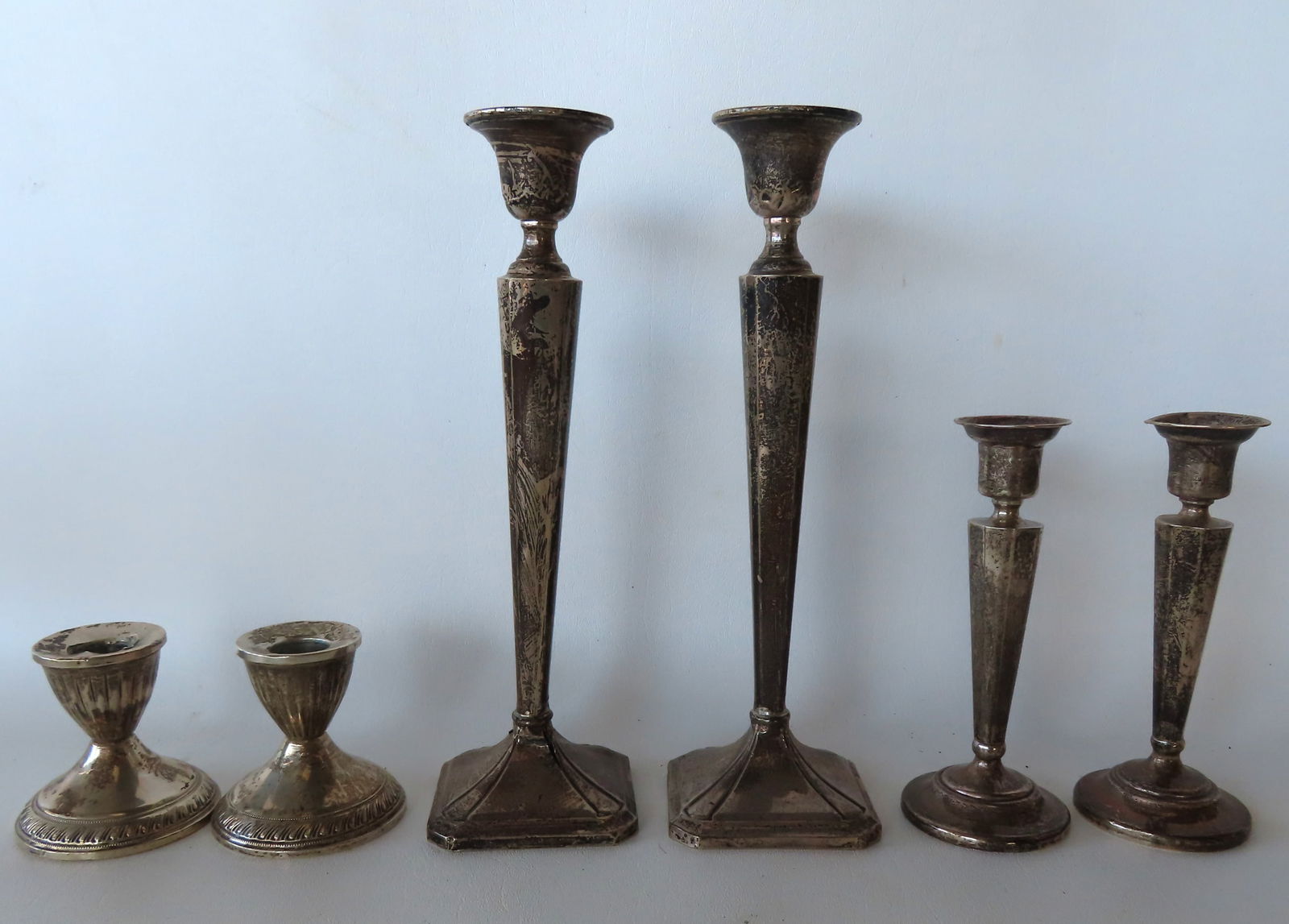 Grouping of 3 pair of weighted sterling silver candlesticks, the intermediate size sticks are in (1 of 3)