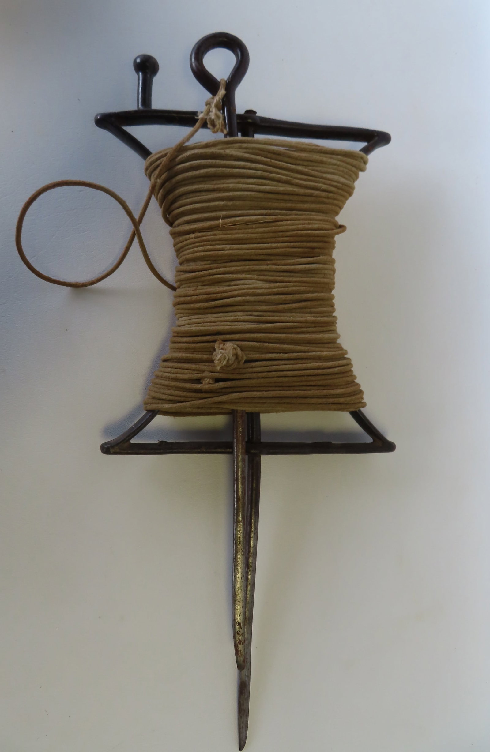 A hand forged iron garden string line holder, 19th century - very good condition. Measures 19 1/2"H: A hand forged iron garden string line holder, 19th century - very good condition. Measures 19 1/2"H x 8 1/2"W.