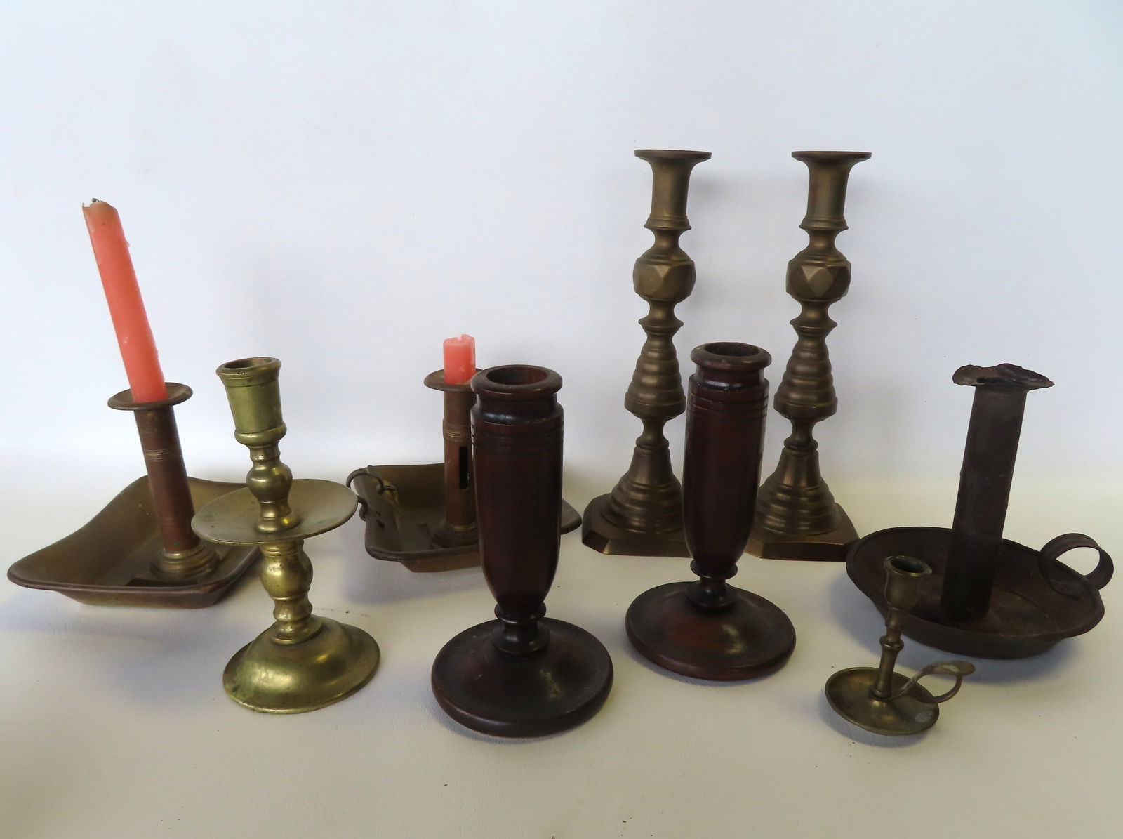 A grouping of wood, brass and tin 19th century candle lighting devices. Includes 2 turned wooden (1 of 10)