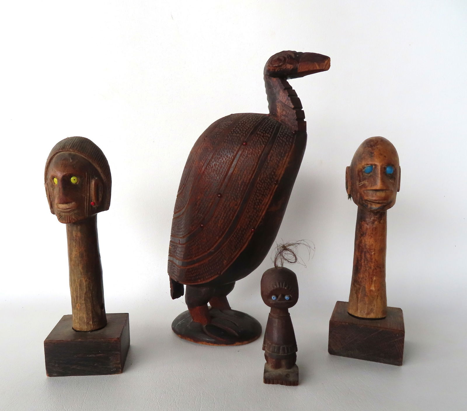 Grouping of African carved wooden objects including stylized bird with feathering and applied small (1 of 15)