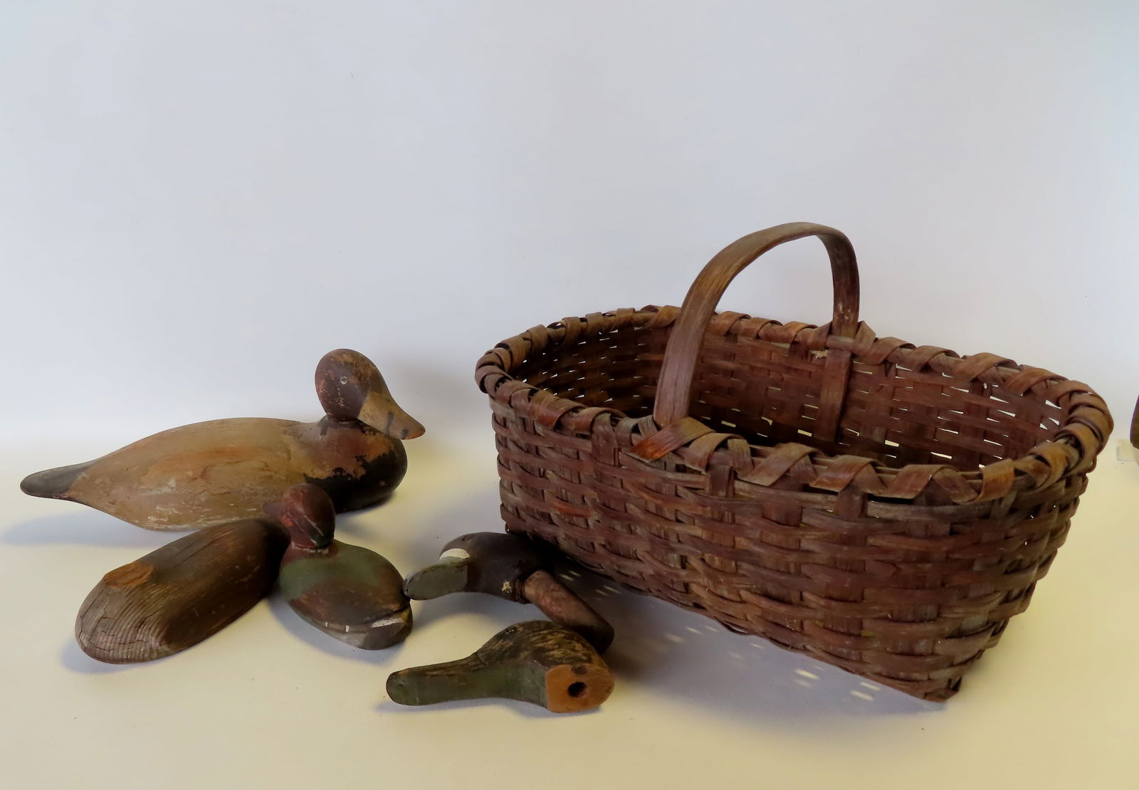 An early splint basket and decoys and decoy heads. The splint basket with single loop handle is in (1 of 12)