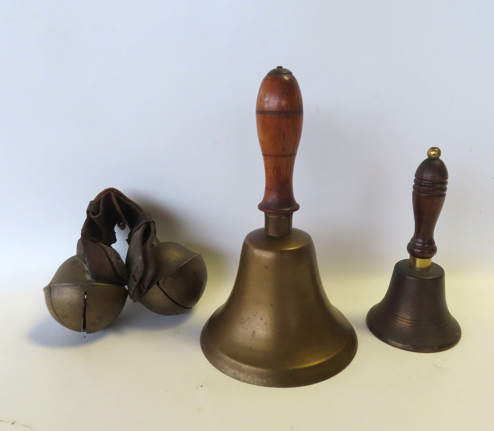 Three brass bells including large pair of brass sleigh bells, brass school bell - this is the (1 of 7)