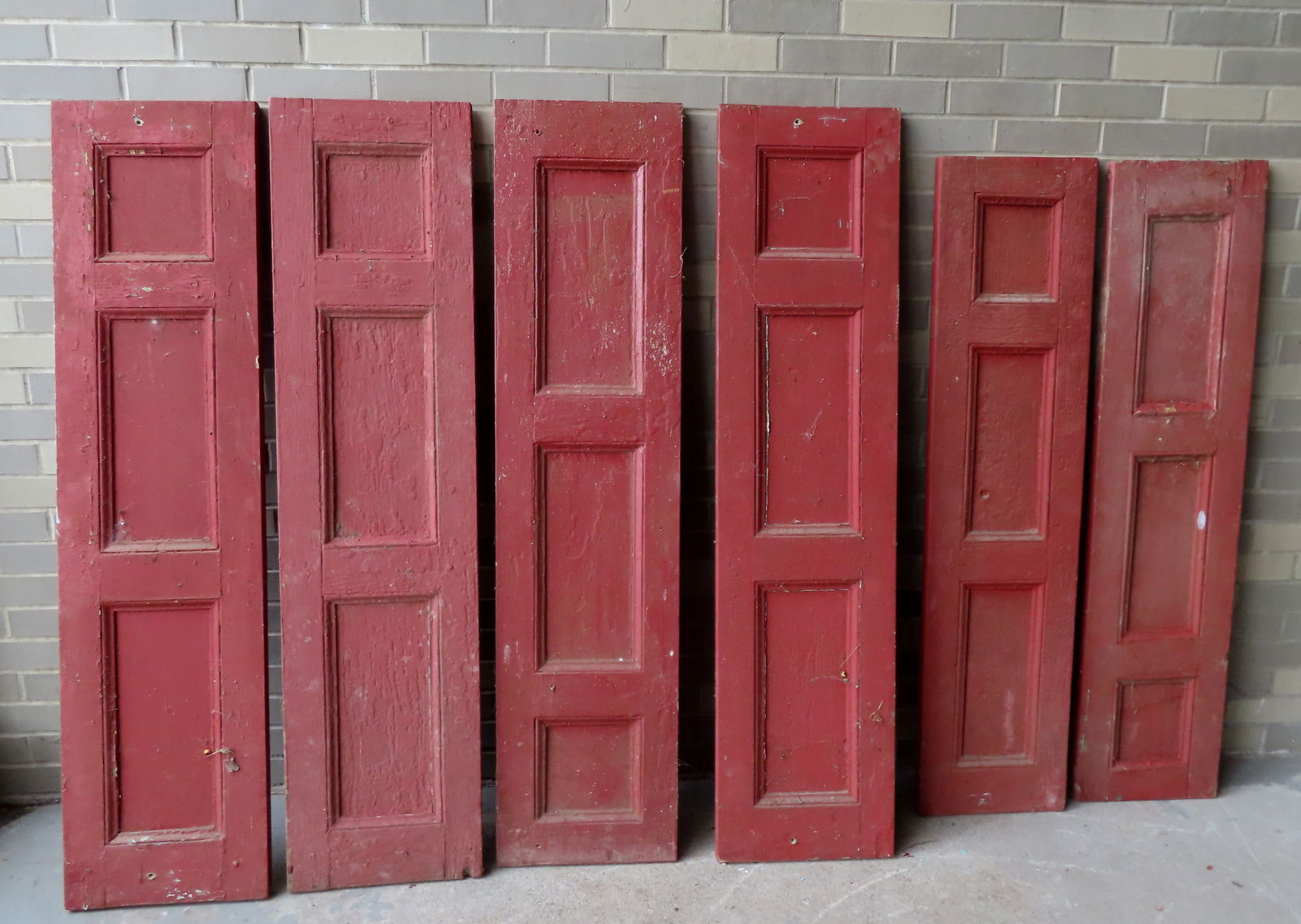 Grouping of 6 paneled wooden shutters, layers of old paint, set of 4 and set of 2, all mid 19th (1 of 6)