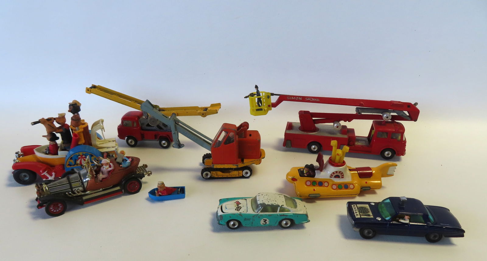 Grouping of 8 Gogi toys, most in good condition - the largest, The Simon Snorkel measuring 9 1/2"L x: Grouping of 8 Gogi toys, most in good condition - the largest, The Simon Snorkel measuring 9 1/2"L x 3 3/4"H. The Popeye vehicle missing part of crown a the top and the life boat is loose, otherwise t