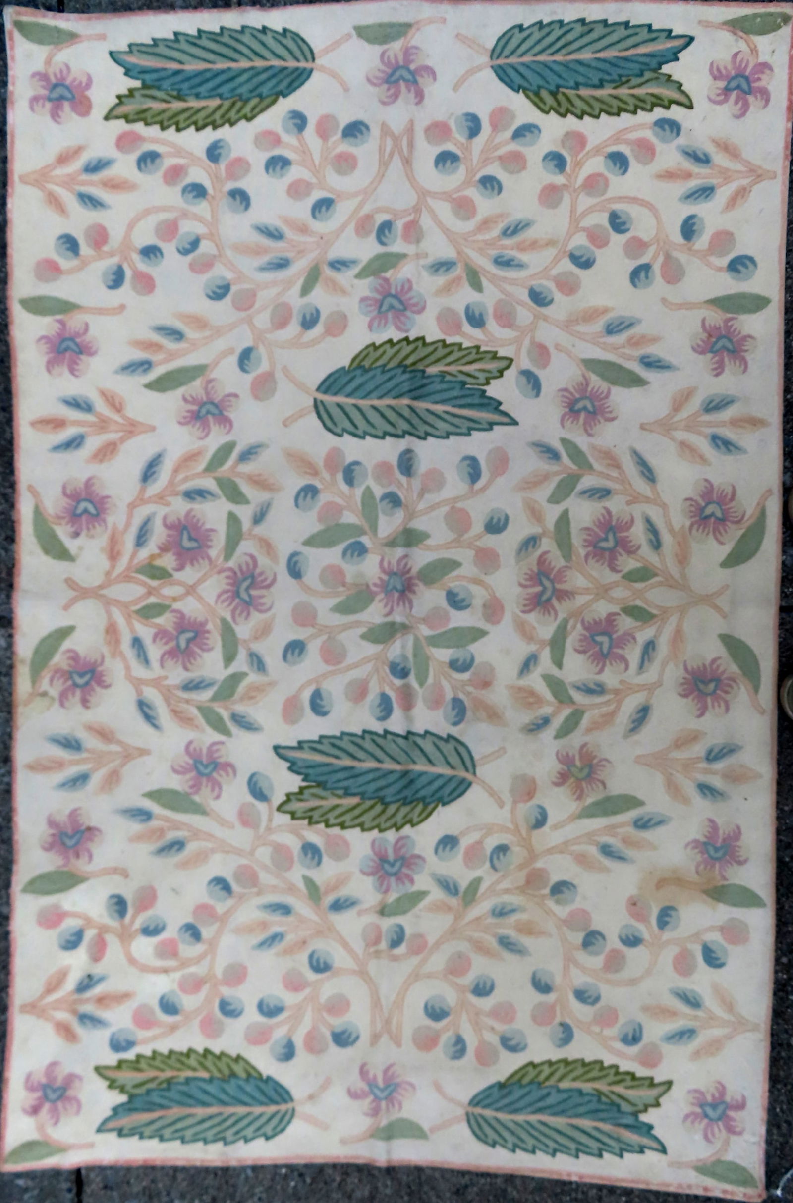 A crewel work scatter rug decorated with leaves and scrolled tree branches. (1 of 6)