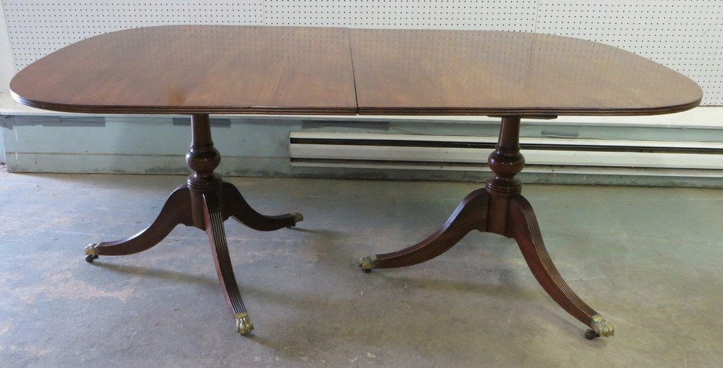 Fine mahogany Duncan Phyfe style DR table. Double: Fine mahogany Duncan Phyfe style DR table. Double turned pedestals and reeded legs leading to claw foot & casters. Two 16" leaves. Note beading around perimeter of table - 6' L x 3' 8"W x 2' 5"H. Exce