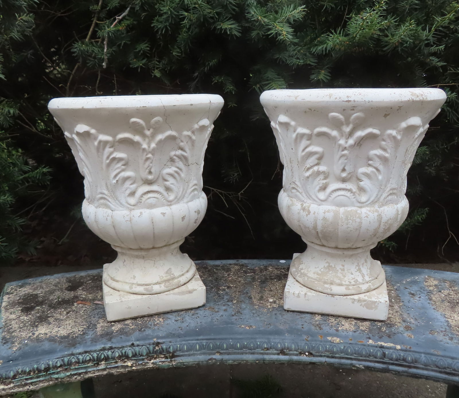 Two matching concrete garden urns, in old white paint, circa 1950-70. One with hairline cracks, else: Two matching concrete garden urns, in old white paint, circa 1950-70. One with hairline cracks, else good condition. Each measures 16 1/2"H x 13" diameter.