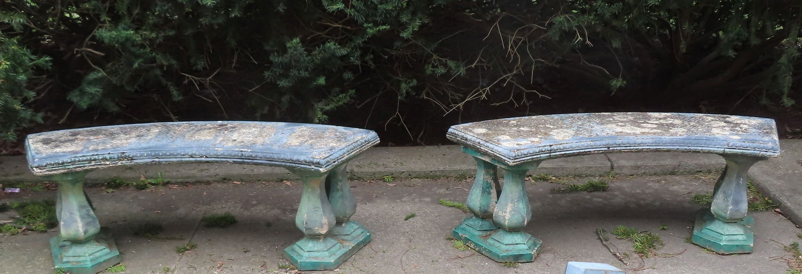 Two matching concrete garden benches, each with curved tops mounted on double pedestals, and traces: Two matching concrete garden benches, each with curved tops mounted on double pedestals, and traces of original paint (each with 3 removable sections), probably mid 20th century. Both with lichen on s