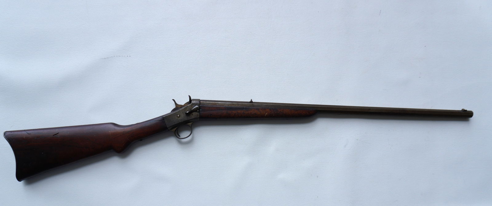 Remington 22 cal, single shot, rolling block rifle, walnut stock, octagonal barrel - 23 5/8" - total: Remington single shot, rolling block rifle, walnut stock, octagonal barrel - 23 5/8" - total length 39" - not marked but likely .32 cal. Good clean rifle with small hairline in walnut forearm. Provena