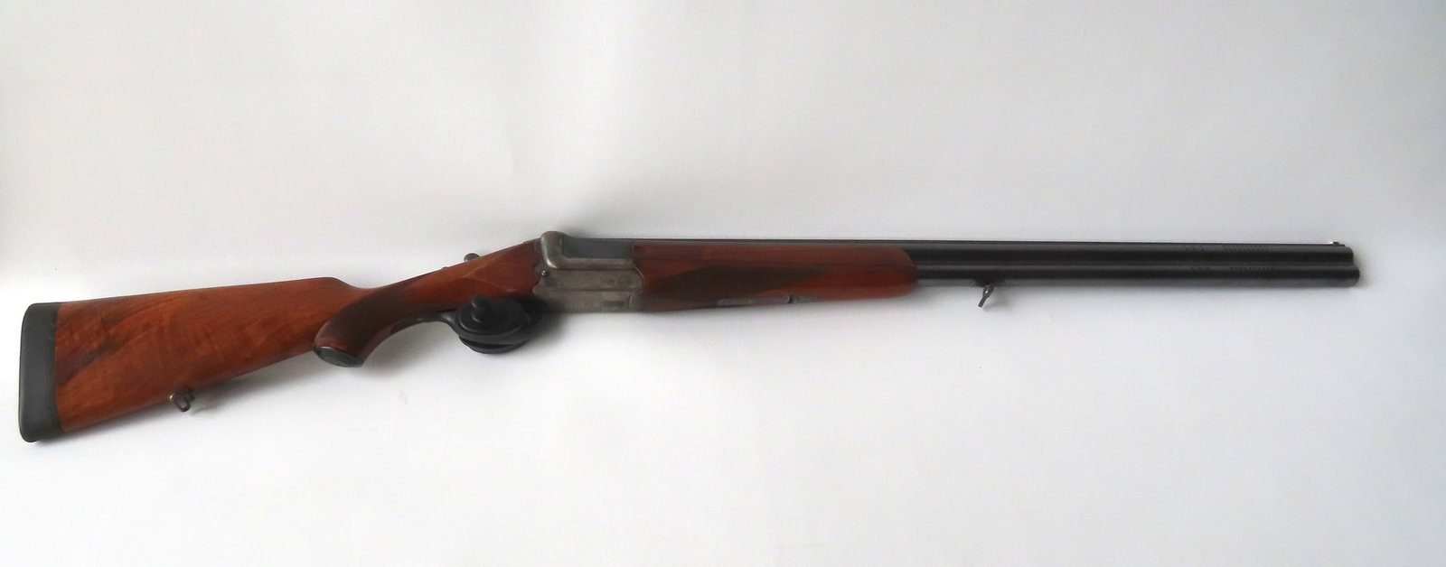 Gusloff-Werk over and under 12 ga. shotgun signed "Gusloff-Werke / Waffenwerk Suhl" - also marked on: Gusloff-Werk over and under 12 ga. shotgun signed "Gusloff-Werke / Waffenwerk Suhl" - also marked on side of barrel "Fluss-Stahl / Krupp-Essen". Checkered walnut stock with cheek rest, and padded butt