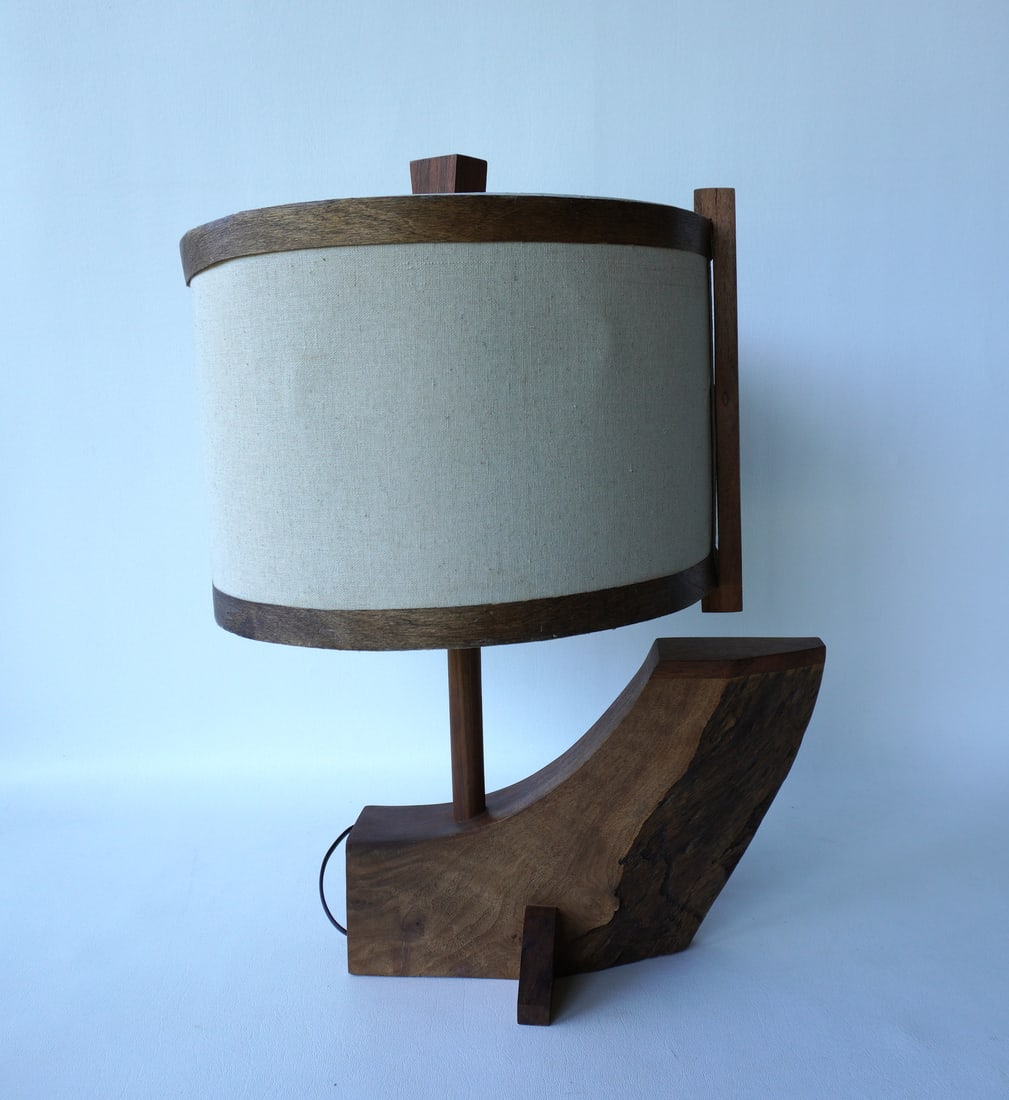 A vintage unsigned Nakashima style walnut desk or table lamp with original shade circa 1970. The: A vintage unsigned Nakashima style walnut desk or table lamp with original shade circa 1970. The lamp is in very good condition - the shade with matching wooden straps at the top and bottom of the sha
