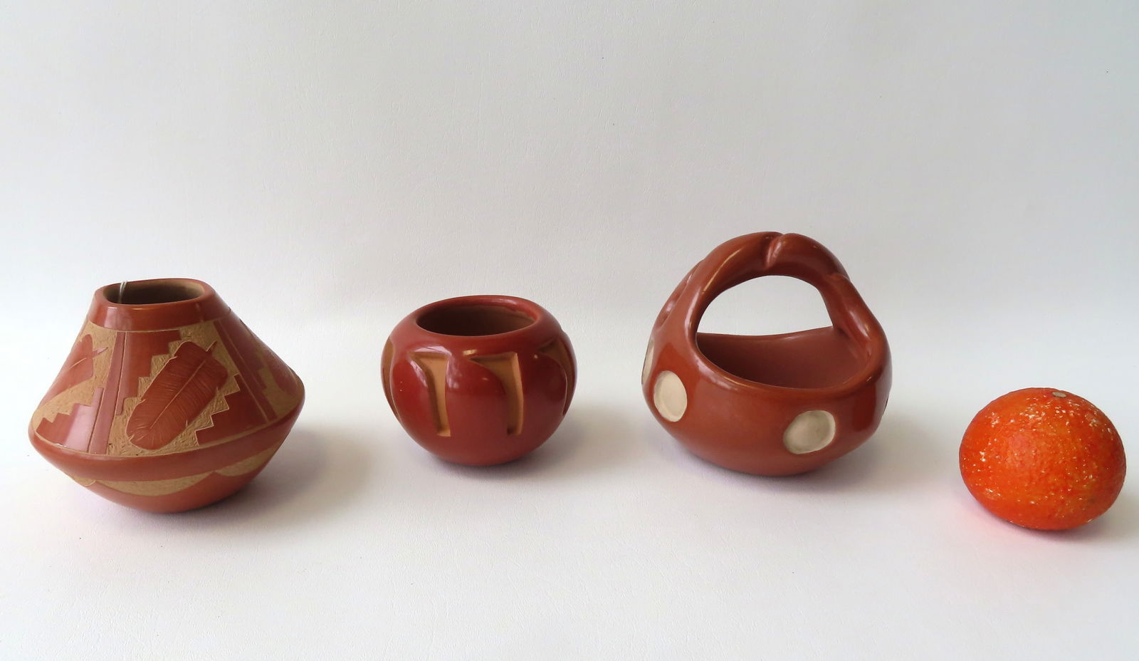 Three Santa Clara redware pottery bowls including: Bowl with twisted handle and deep carved circles: Three Santa Clara redware pottery bowls including: Bowl with twisted handle and deep carved circles around perimeter of body signed "Paul Tafoya / Santa Clara" - very good condition, no chips, cracks
