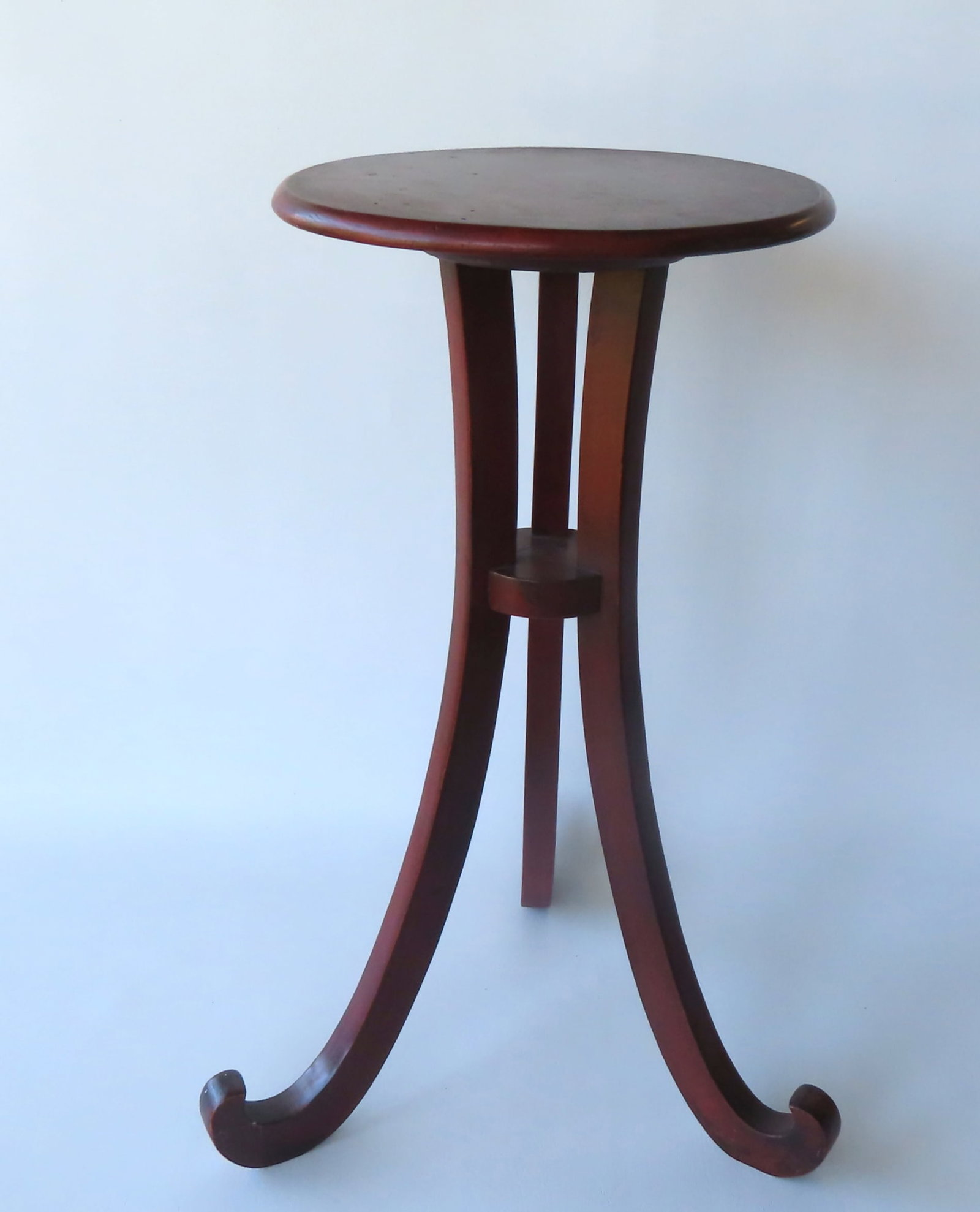 An early tri-leg candlestand with turned feet in original red stain, round top, early 19th century.: An early tri-leg candlestand with turned feet in original red stain, round top, early 19th century. Measures 16 1/2" diameter at base x 25 1/2"H. Very good condition.