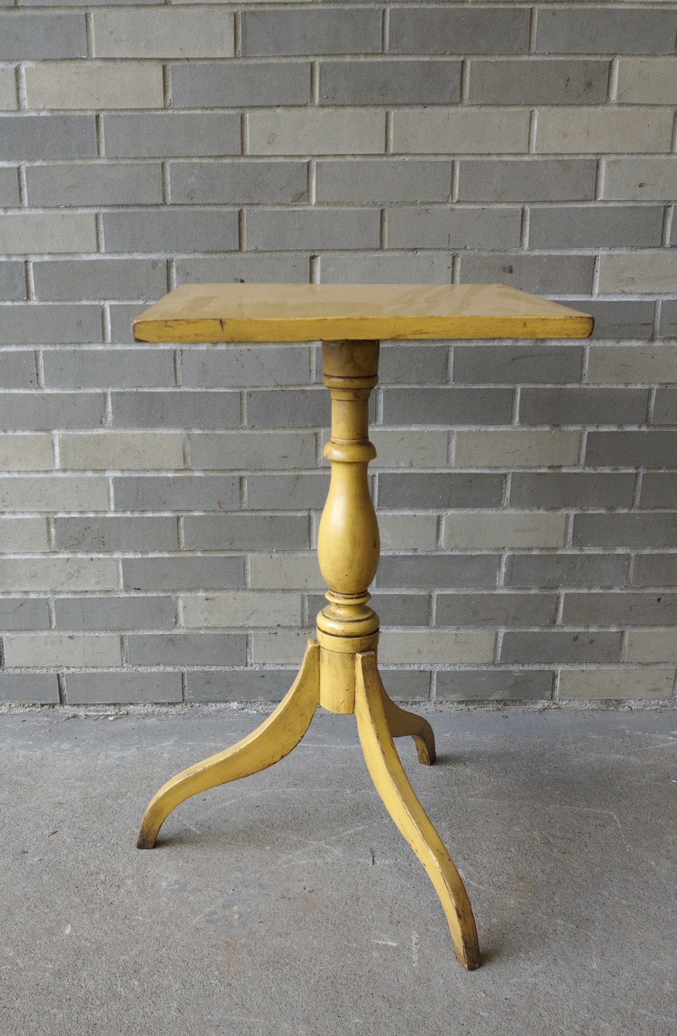 Hepplewhite spider leg candlestand with one board top and nicely turned pedestal in a newer mustard: Hepplewhite spider leg candlestand with one board top and nicely turned pedestal in a newer mustard paint, circa 1820. Good condition. Measures 17" x 18" top x 28 3/4'H. Provenance: From a Rochester N