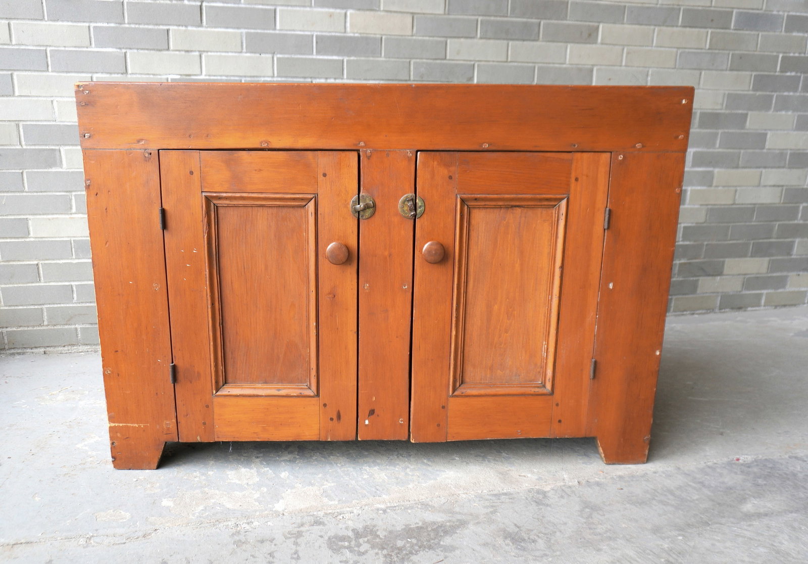 Refinished pine dry sink having an open well over 2 paneled doors on cutout base, minor use wear and: Refinished pine dry sink having an open well over 2 paneled doors on cutout base, minor use wear and overall good condition, circa 1850-60. Measures 43"W x 19"D x 29"H. Provenance: From a Scarsdale NY