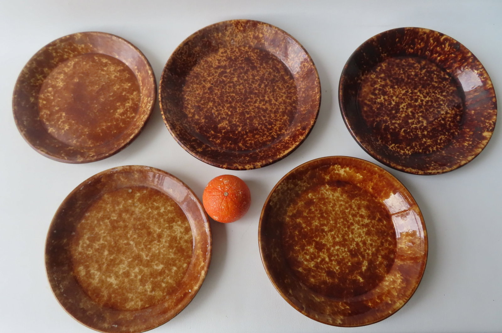 Grouping if 5 early Bennington spongeware plates, the largest 11" diameter. One with a tiny glazing: Grouping if 5 early Bennington spongeware plates, the largest 11" diameter. One with a tiny glazing flake on edge, else all in very good condition with no damage - 19th century. Provenance: From the C