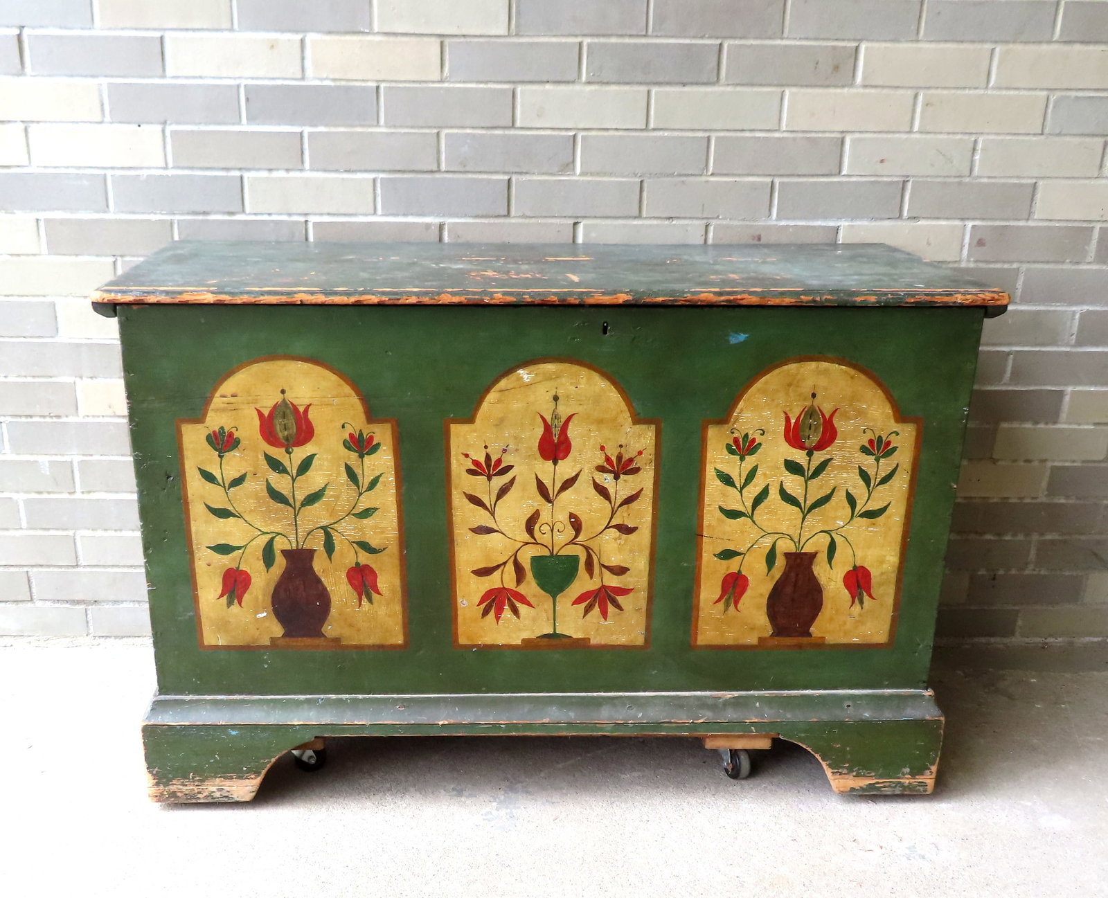 Pennsylvania hand painted dower chest decorated with tulips in urns on 3 sides, having a molded edge: Pennsylvania hand painted dower chest decorated with tulips in urns on 3 sides, having a molded edge to cleated lid, and mounted on original bracket base. Condition: Likely late 19th century second pa