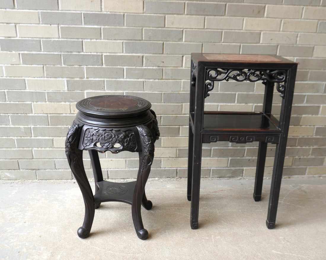 Two oriental plant stand. The first heavily carved ebonized wood with circular top and cabriole: Two oriental plant stand. The first heavily carved ebonized wood with circular top and cabriole style legs - 18 1/2" W x 24"H; the second, with a pink marble top, scrolled skirt and lower shelf - 16 1
