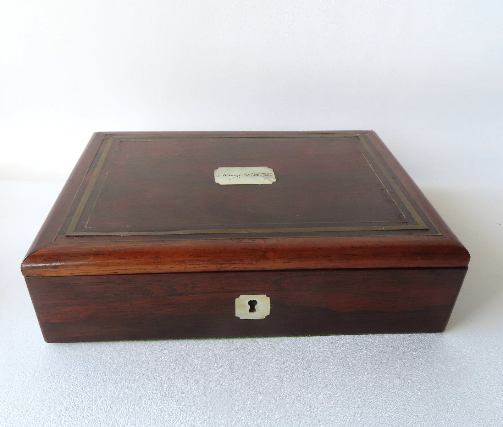 A beautiful rosewood writing box with brass inlay - the lid with an inlaid mother-of-pearl medallion: A beautiful rosewood writing box with brass inlay - the lid with an inlaid mother-of-pearl medallion signed Mary F. Foulke and a mother-of-pearl escutcheon. The interior with 2 lidded compartments and