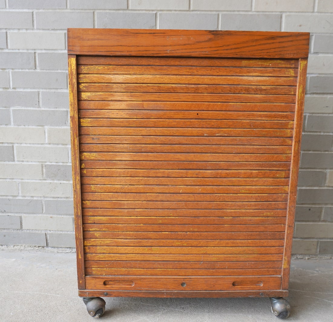 An oak Stanley tool chest with tambour door and tool holders on interior with fitted lower drawer -: An oak Stanley tool chest with tambour door and tool holders on interior with fitted lower drawer - very good condition, early 20th century - partial Stanley label on interior. 23"W x 8"D x 30 1/2"H.