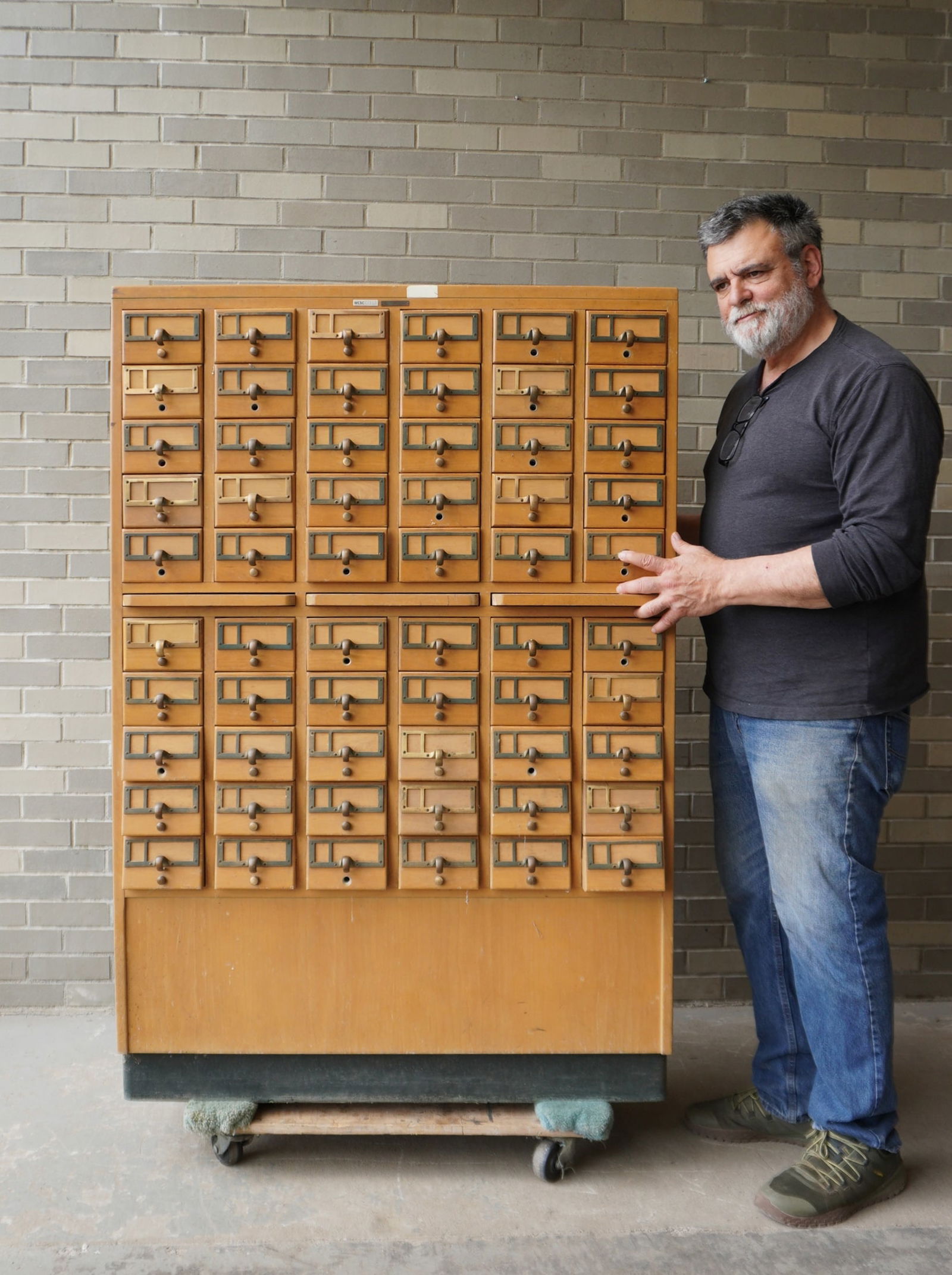A maple library cabinet having 60 small pull out drawers with brass handles and brass label holders,: A maple library cabinet having 60 small pull out drawers with brass handles and brass label holders, signed "Standard Works Products Corp./ Library Division / New York NY" - 40"W x 18 3/4"D x 58 7/8"H