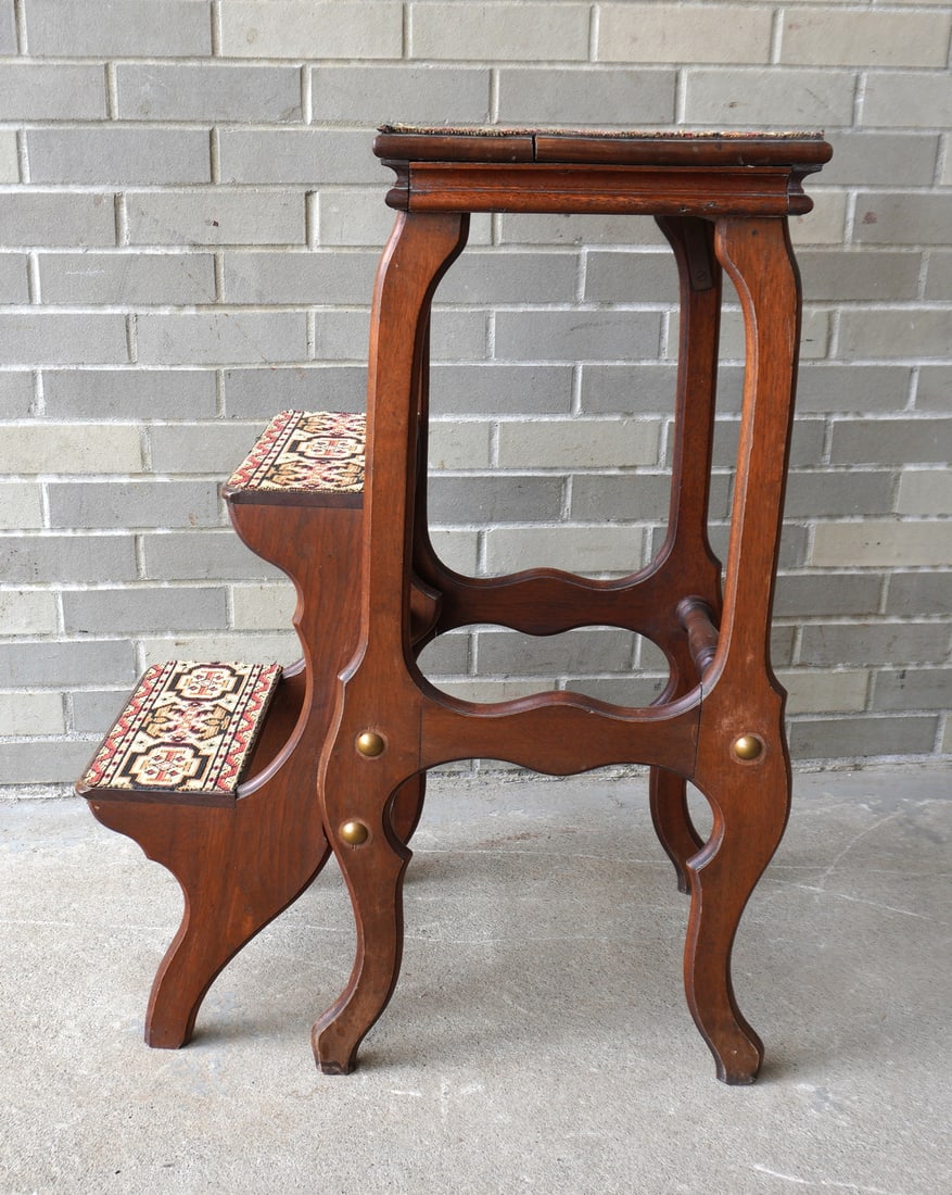 A Victorian walnut fold-up library stool with carpet lined steps, late 19th century. Very good: A Victorian walnut fold-up library stool with carpet lined steps, late 19th century. Very good condition. Measures 16 1/2"W x 16"D (in folded up position) x 32 3/4"H. Provenance: From a Rochester NY e