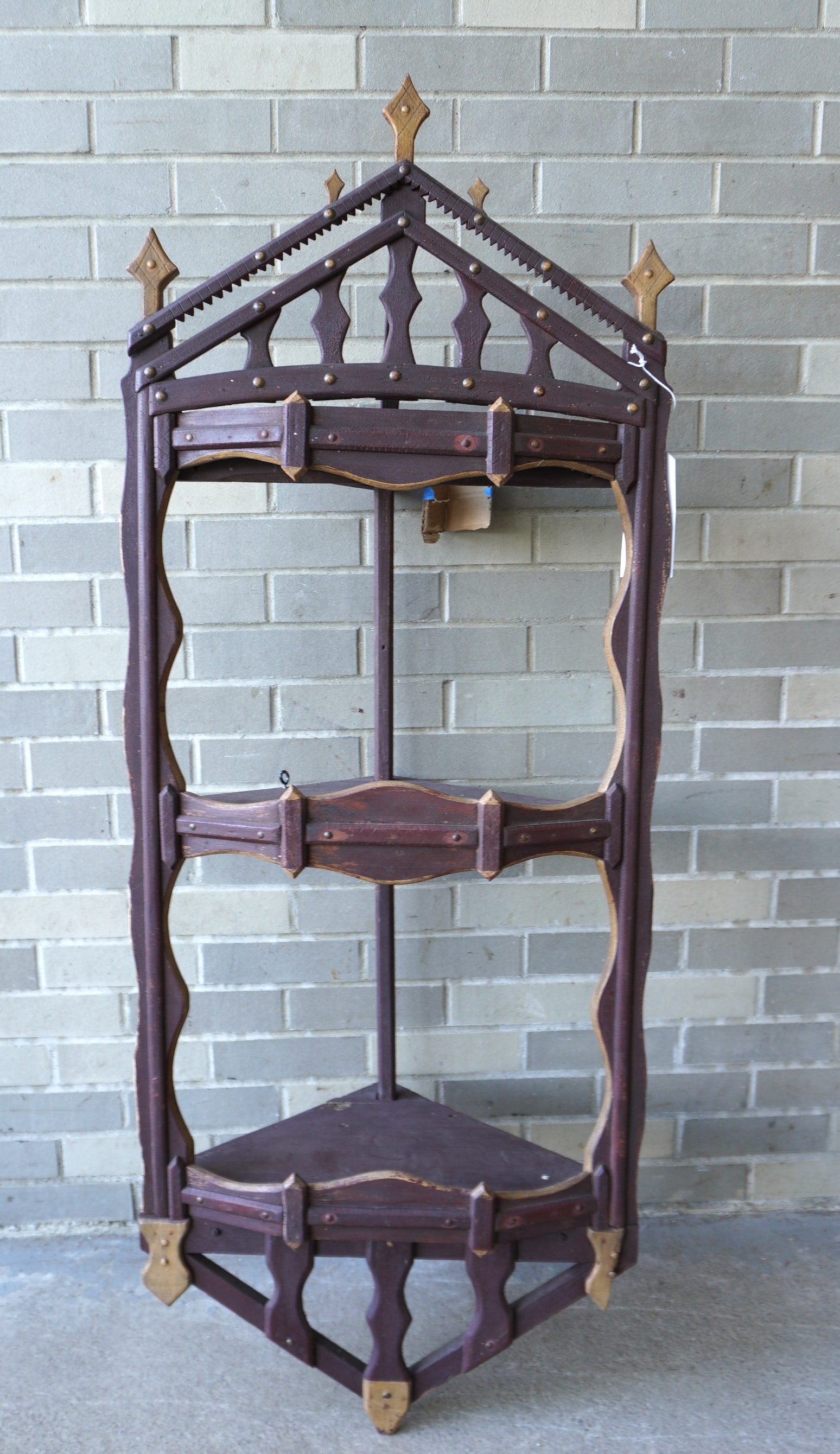 A large 2 tier folk art wooden corner wall shelf in original brown paint with mustard colored: A large 2 tier folk art wooden corner wall shelf in original brown paint with mustard colored highlights, open front and sides, late 19th century - missing small piece of bottom ornament, else good co