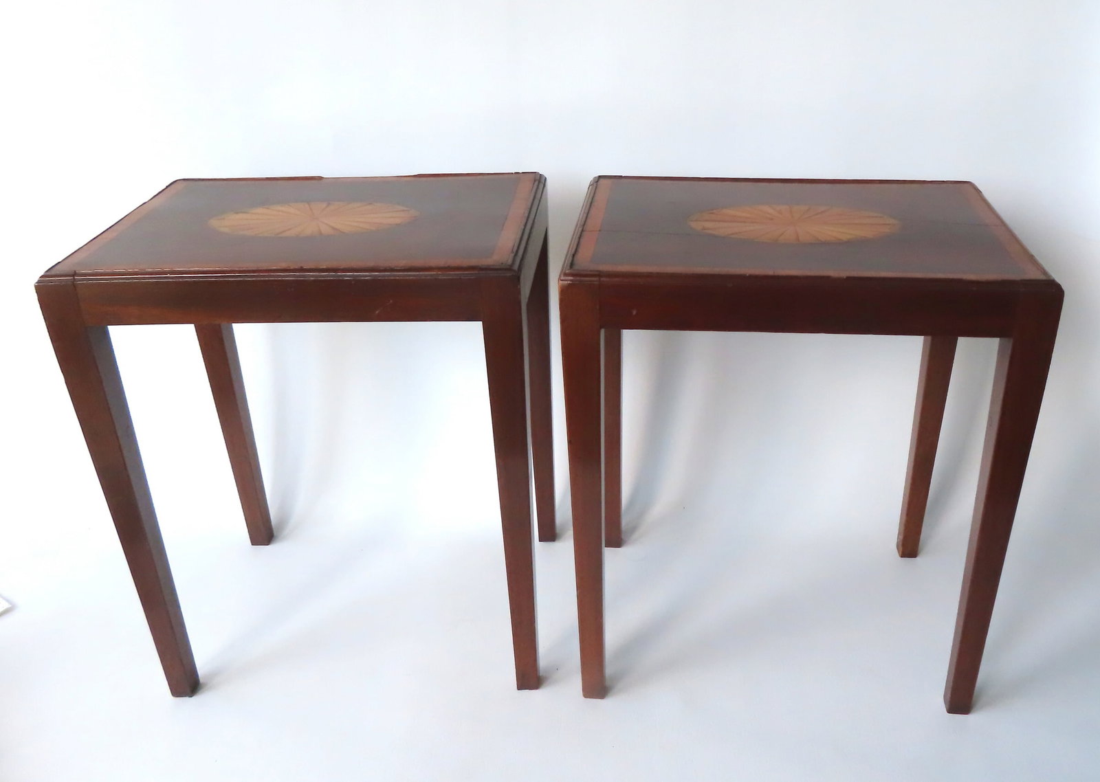 Two very fine matching mahogany Hepplewhite stands in small size. The top having a molded edge with: Two very fine matching mahogany Hepplewhite stands in small size. The top having a molded edge with inlaid banded border and inlaid satinwood oval sunburst in center, early to mid 19th century. Both r