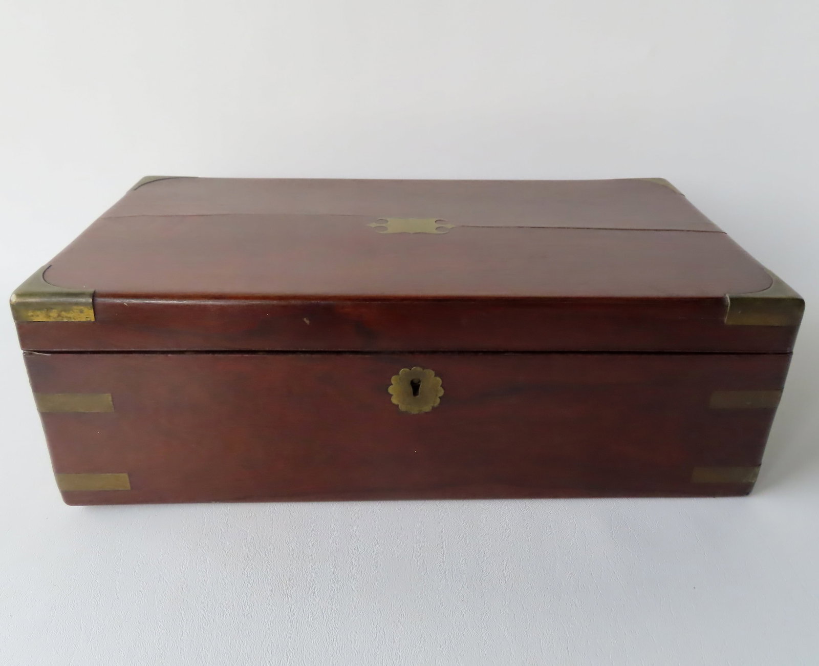 A good mahogany writing box with fitted inkwell compartments, writing service, hidden drawers and: A good mahogany writing box with fitted inkwell compartments, writing service, hidden drawers and brass supports in all corners. The release for the hidden compartment does not always release and need