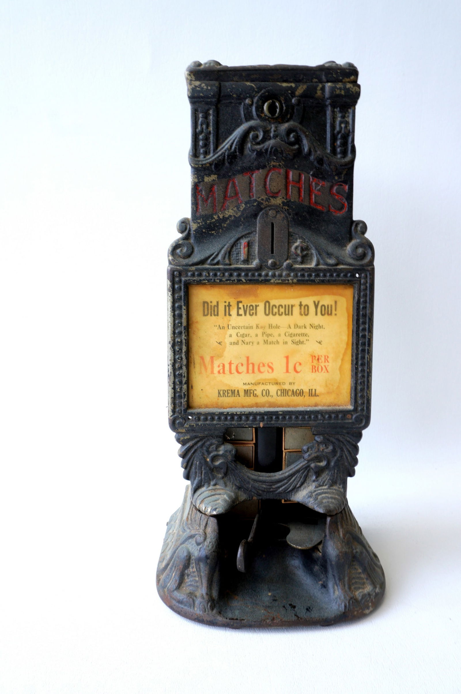 A Krema cast iron 1 cent match box dispenser signed Krema Mfg. Co., Chicago, Ill. - note the: A Krema cast iron 1 cent match box dispenser signed Krema Mfg. Co., Chicago, Ill. - note the embossed griffins on the base of dispenser. Comes with 7 Independence Safety Match boxes, all in good condi