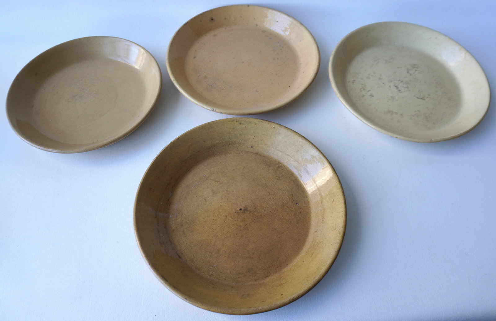Grouping of 4 yelloware pie plates - all with some crazing, else very good condition with no damage.: Grouping of 4 yelloware pie plates - all with some crazing, else very good condition with no damage. The largest measures 11 3/4" diameter. All 19th century. Provenance: From the Carole Ostergren coll