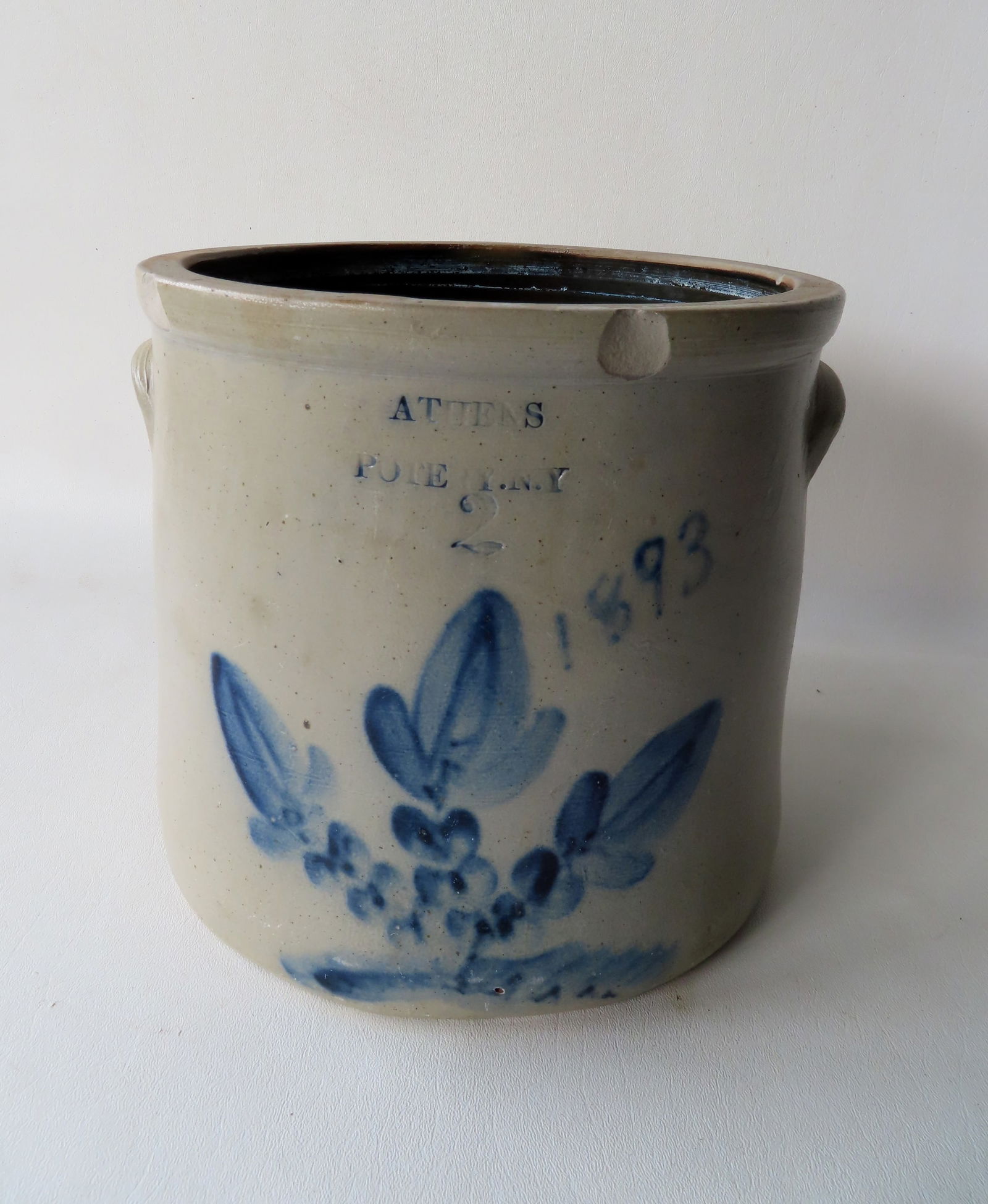 Stoneware crock impressed "ATHENS POTERY. N.Y." (note the misspelling of "pottery"), 2 gallon,: Stoneware crock impressed "ATHENS POTERY. N.Y." (note the misspelling of "pottery"), 2 gallon, decorated with a cobalt blue flower and dated in blue "1893". Three rim chips, else good condition. Measu