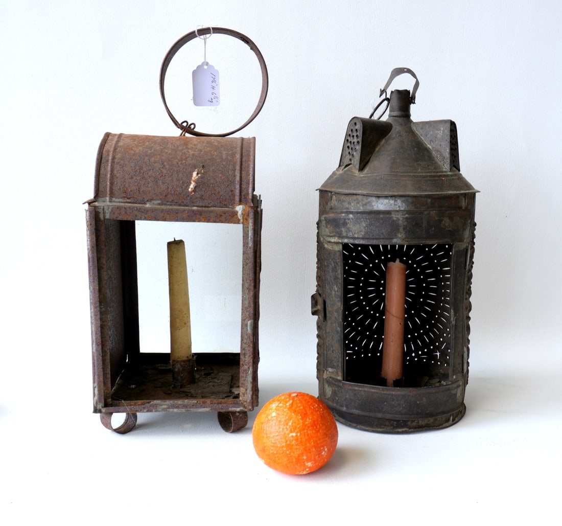 Two early candle lanterns. The first, an unusual Paul Revere type pierced tin lantern with pierced: Two early candle lanterns. The first, an unusual Paul Revere type pierced tin lantern with pierced dormer-like vents on the domed top - missing the glass on the curved front door, some dents in the ti