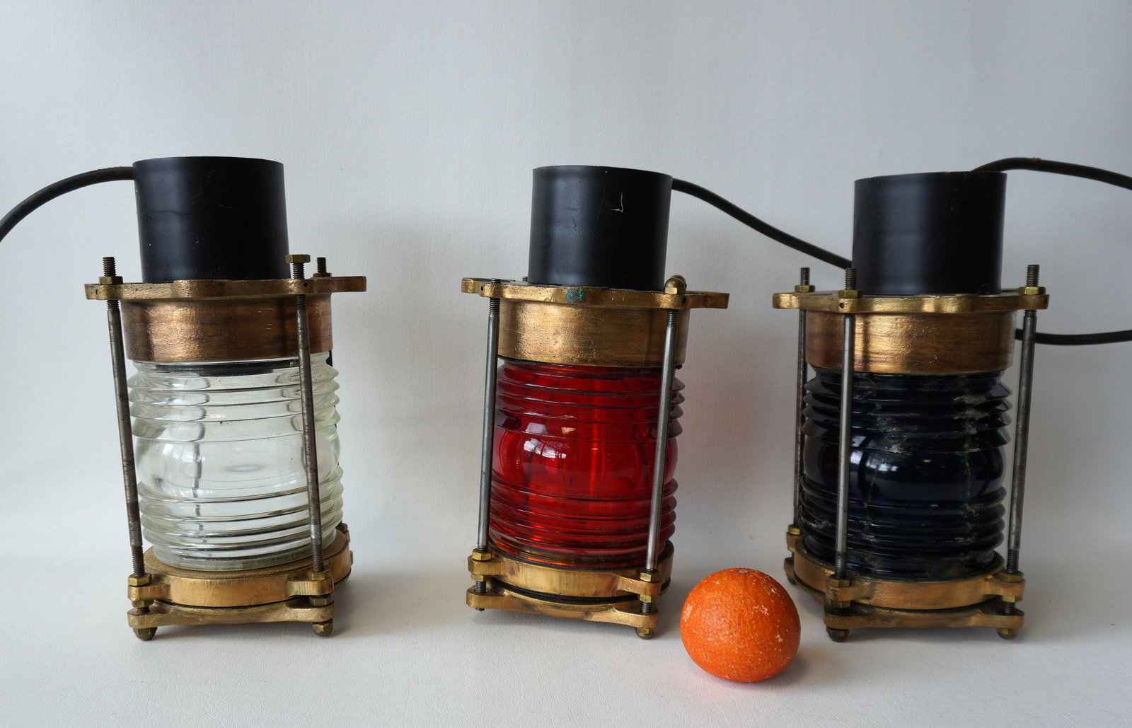 Grouping of 3 nautical brass pier lamps, late 19th to early 20th century, refurbished and: Grouping of 3 nautical brass pier lamps, late 19th to early 20th century, refurbished and electrified, signed GE. Includes 2 with red lens (1 of these is damaged) and 1 colorless, all in good restored