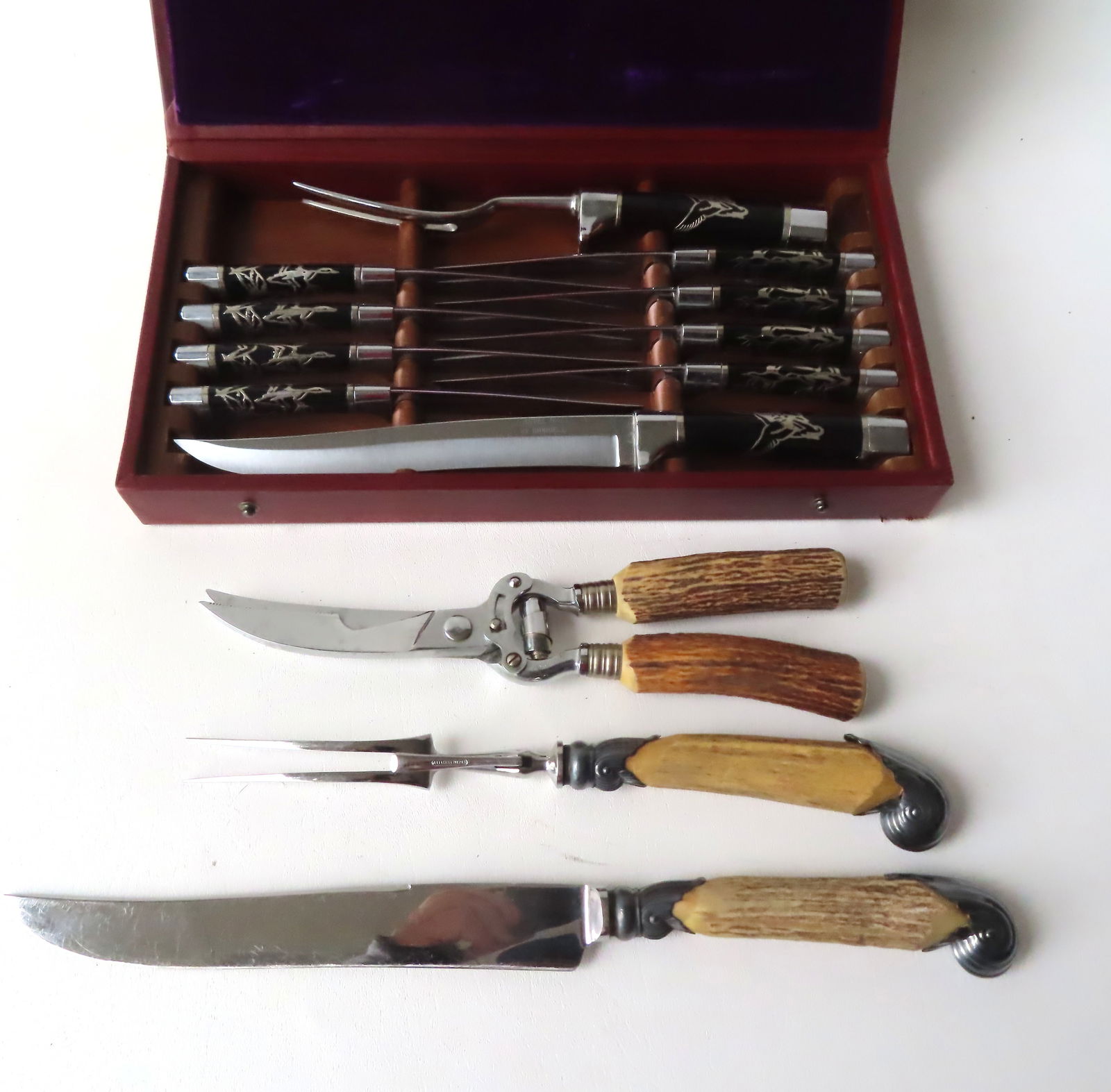 Two very fine cutlery sets: The first a 3 piece set with bone handles signed "William Adams / Made: Two very fine cutlery sets: The first a 3 piece set with bone handles signed "William Adams / Made in Sheffield England" and with silver plated embellishments - very good condition - the largest measu